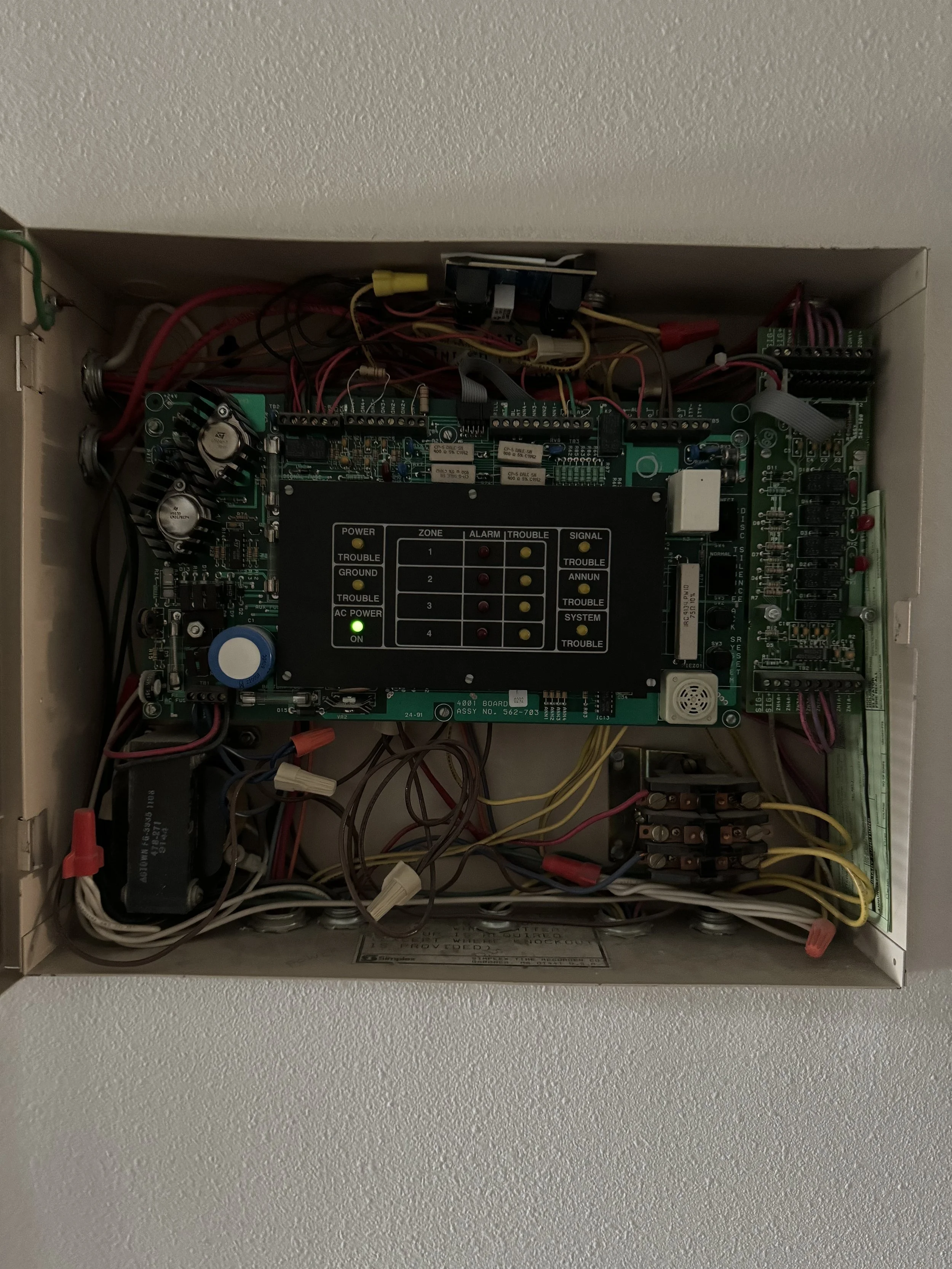 Open fire alarm control panel with wires inside