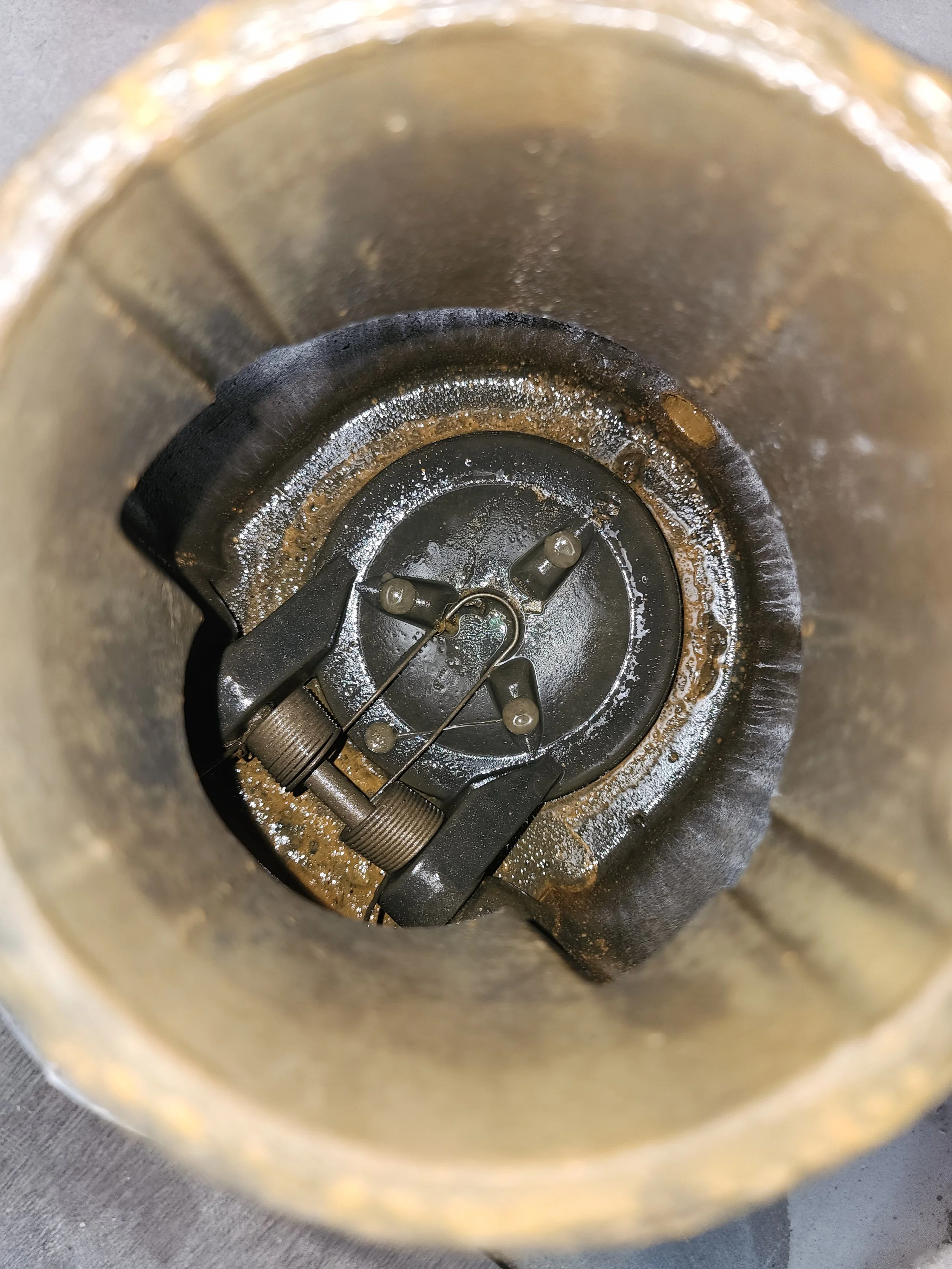 View from the top inside of a rocket or missile engine with metal components and wiring