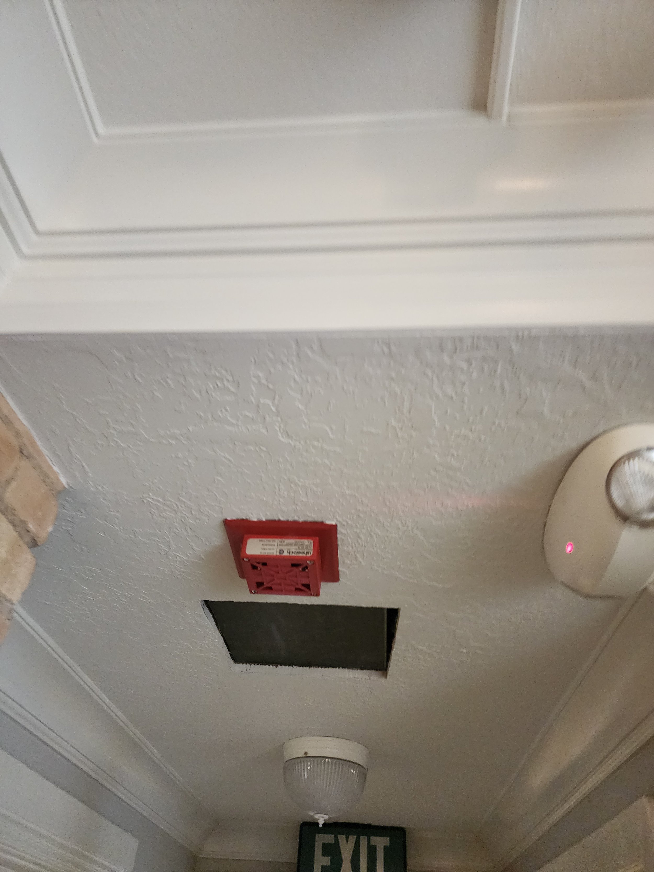 Ceiling with smoke detector, fire alarm, vent, and exit sign