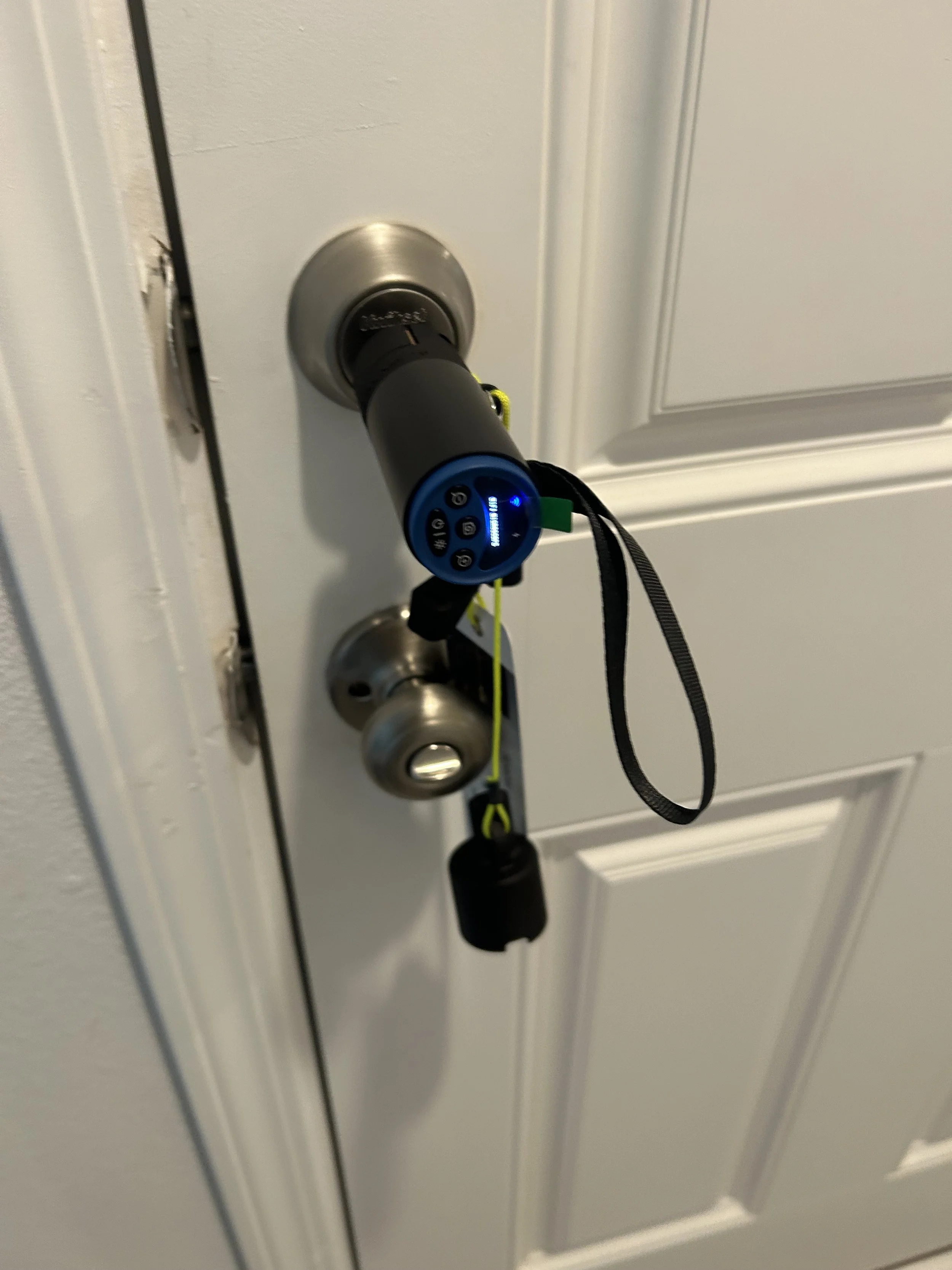 Mobile locksmith decoding a Kwikset SmartKey residential lock using professional optical decoding equipment in Pensacola, Florida.