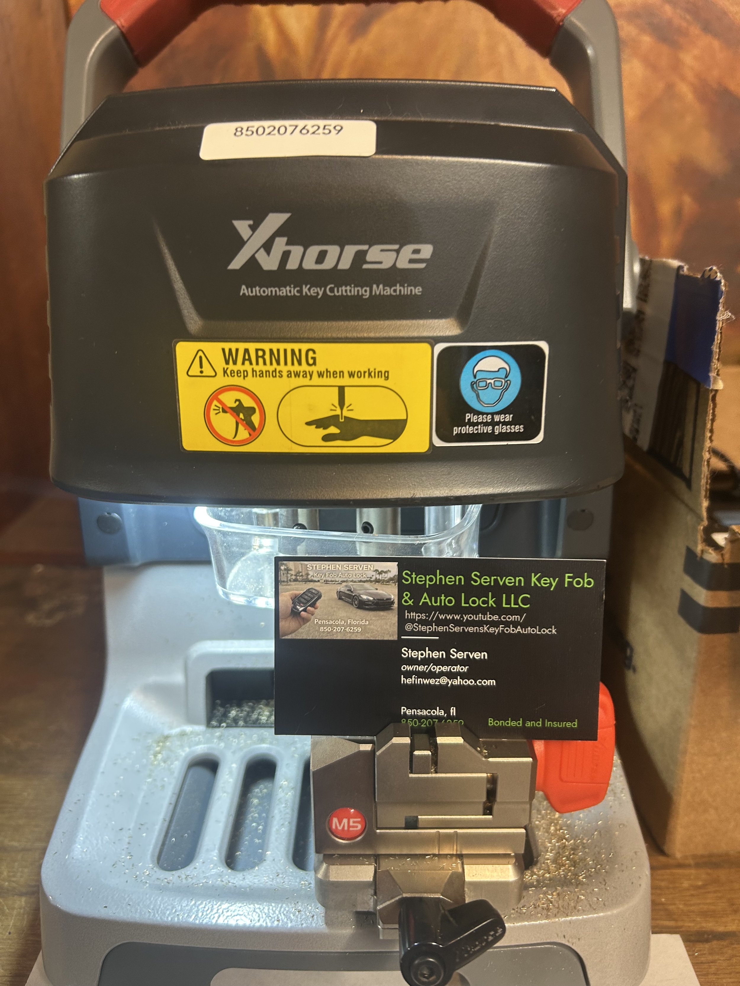 Xhorse key cutting machine with Stephen Serven Key Fob & Auto Lock business card in Pensacola