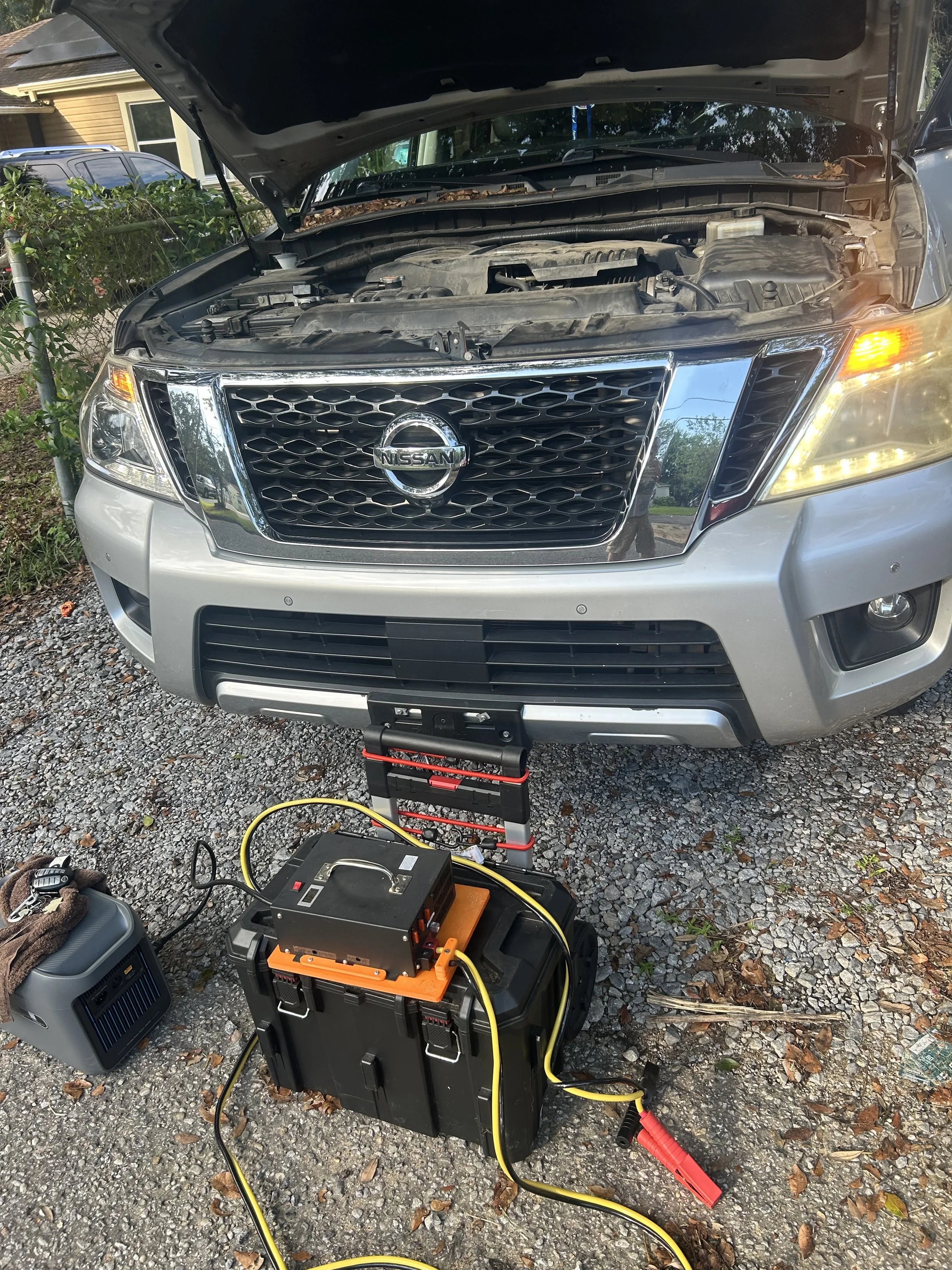 Getting this 2018 Nissan Armada ready for key programming in Pensacola, Florida. The vehicle is about to be connected to a voltage maintainer to keep the battery stable during programming.