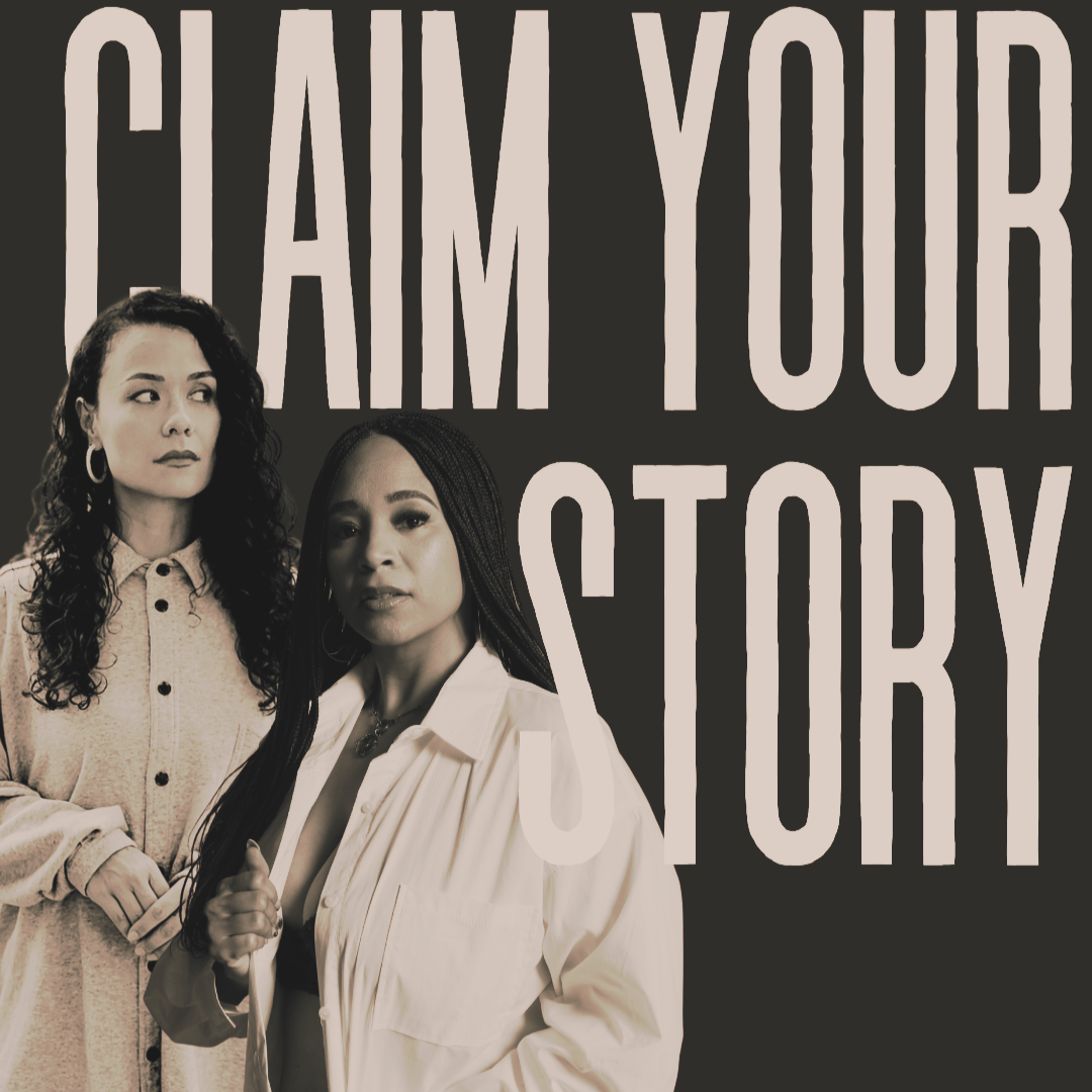 Nighttime city street with blurred lights and reflections, viewed from inside a vehicle.