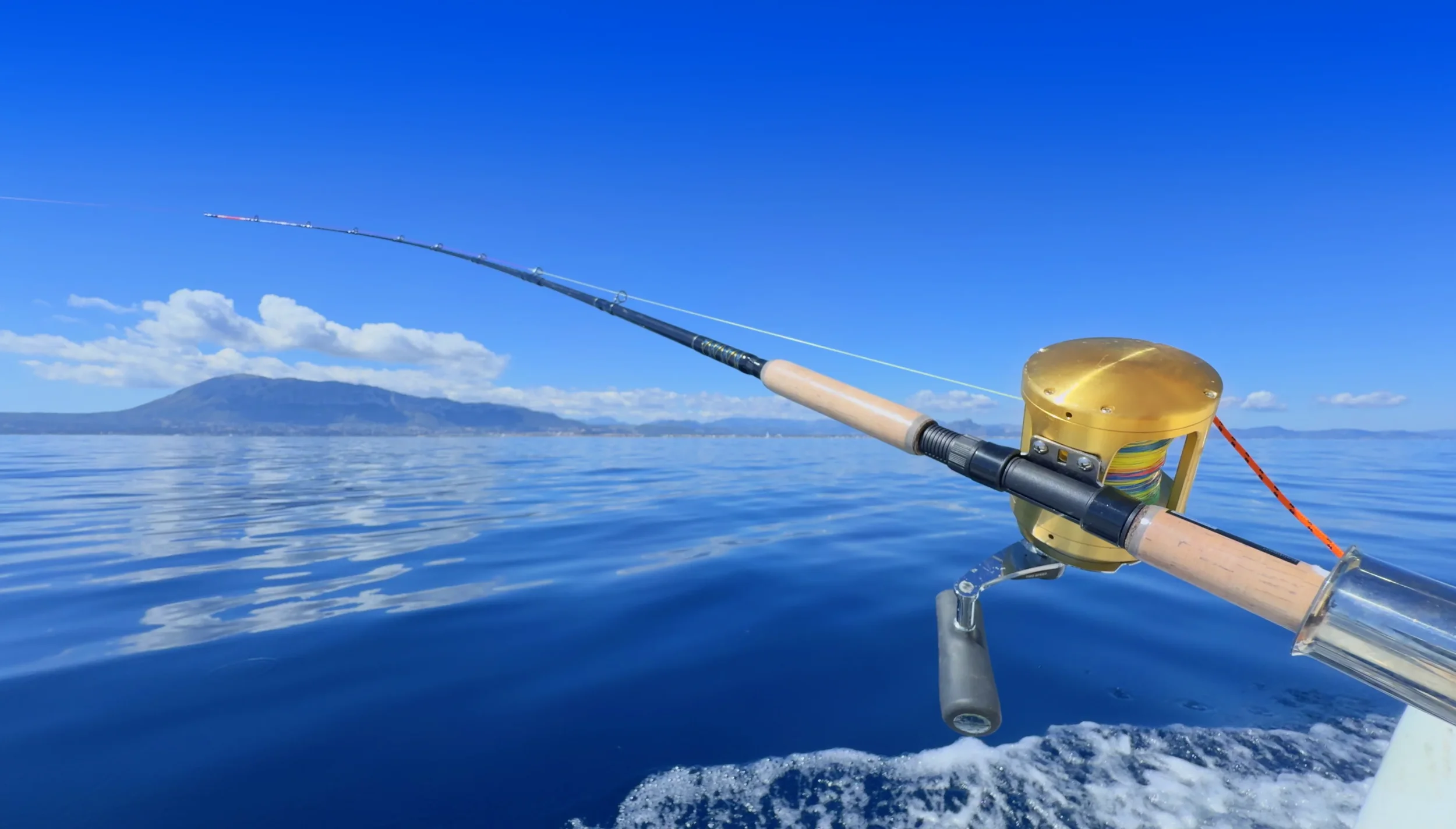 Close-up of a sea fishing rod and reel on a trolling boat off Denia