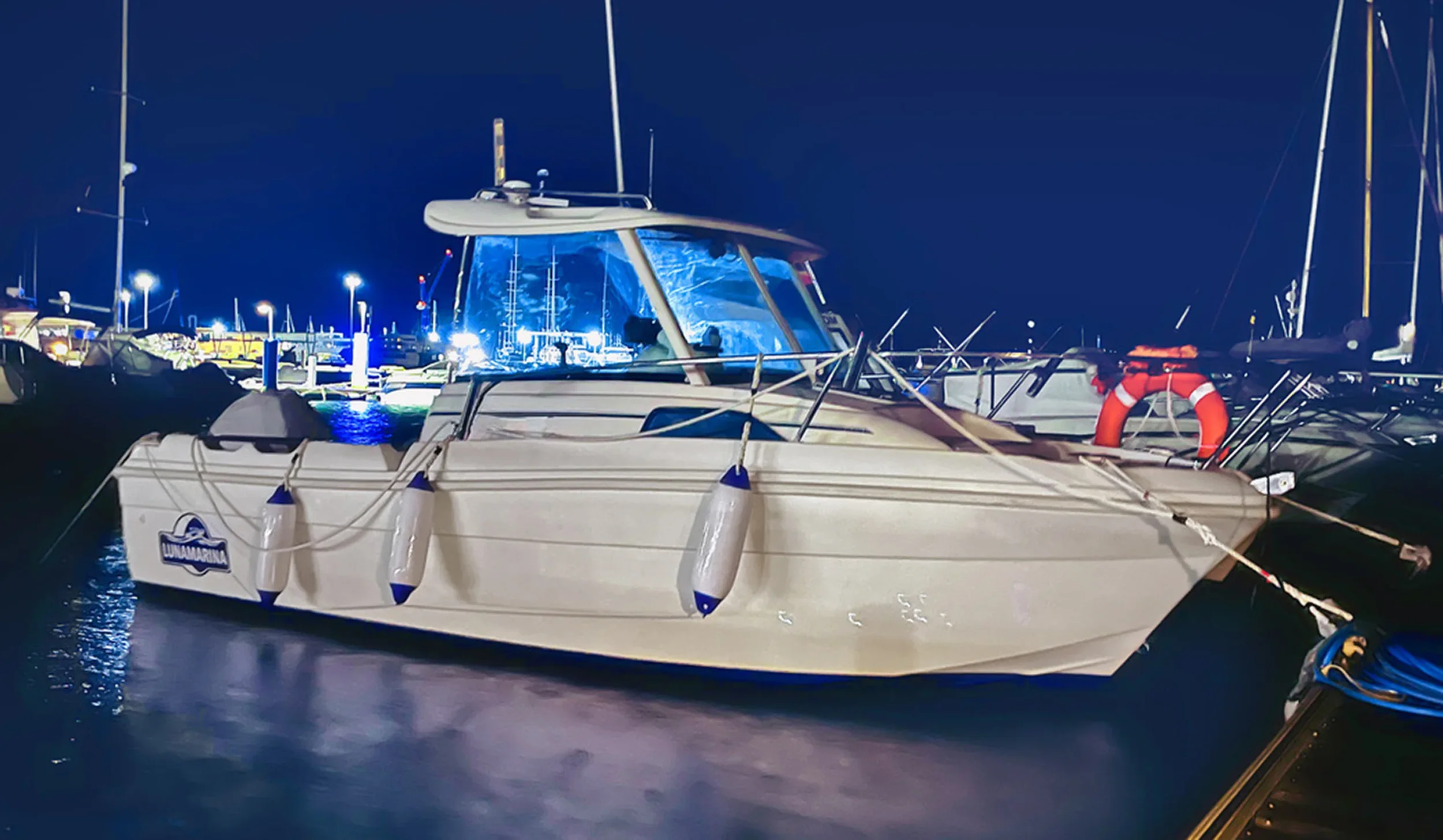 LUNAMARINA charter boat moored at night in Denia harbour