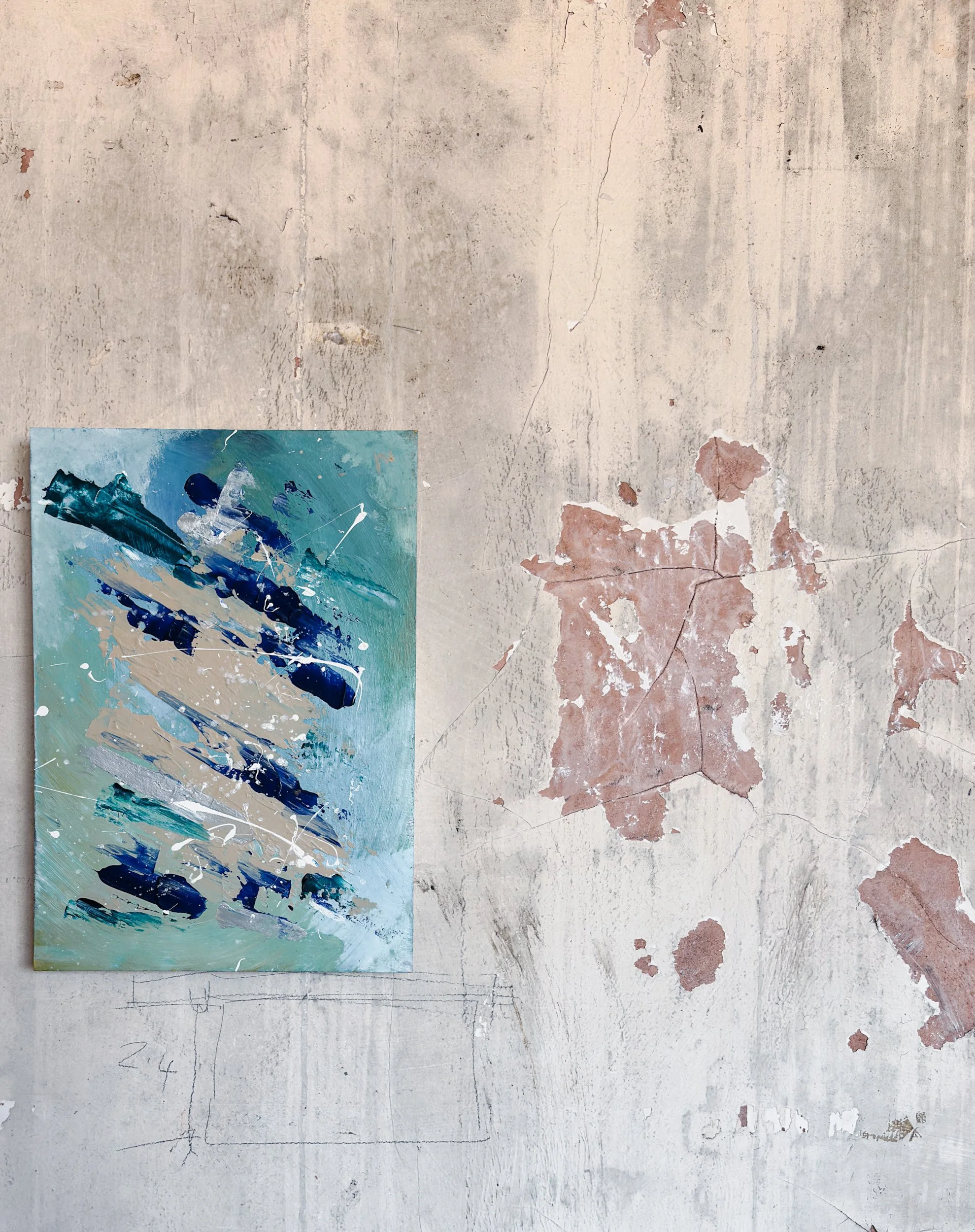 An abstract painting with inspired by the chaos of the sea featuring bold strokes of phthalo blues, greens, sands and white with flicks of white against a distressed wall backdrop.