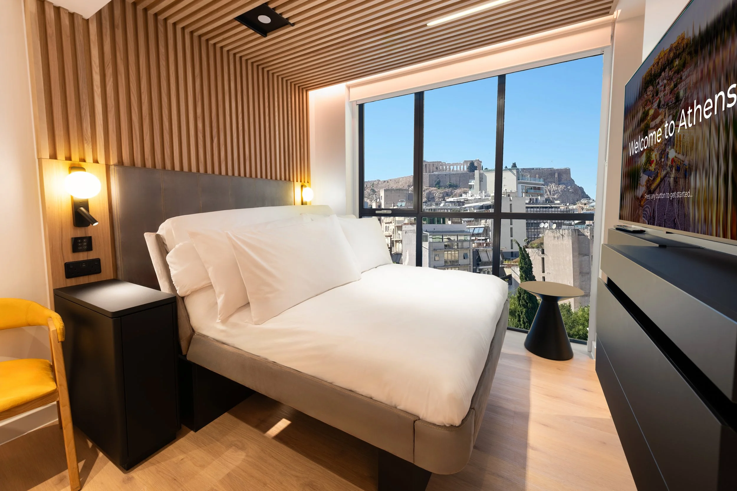 Bedroom with Queen size bed, floor to ceiling window with view of Acropolis