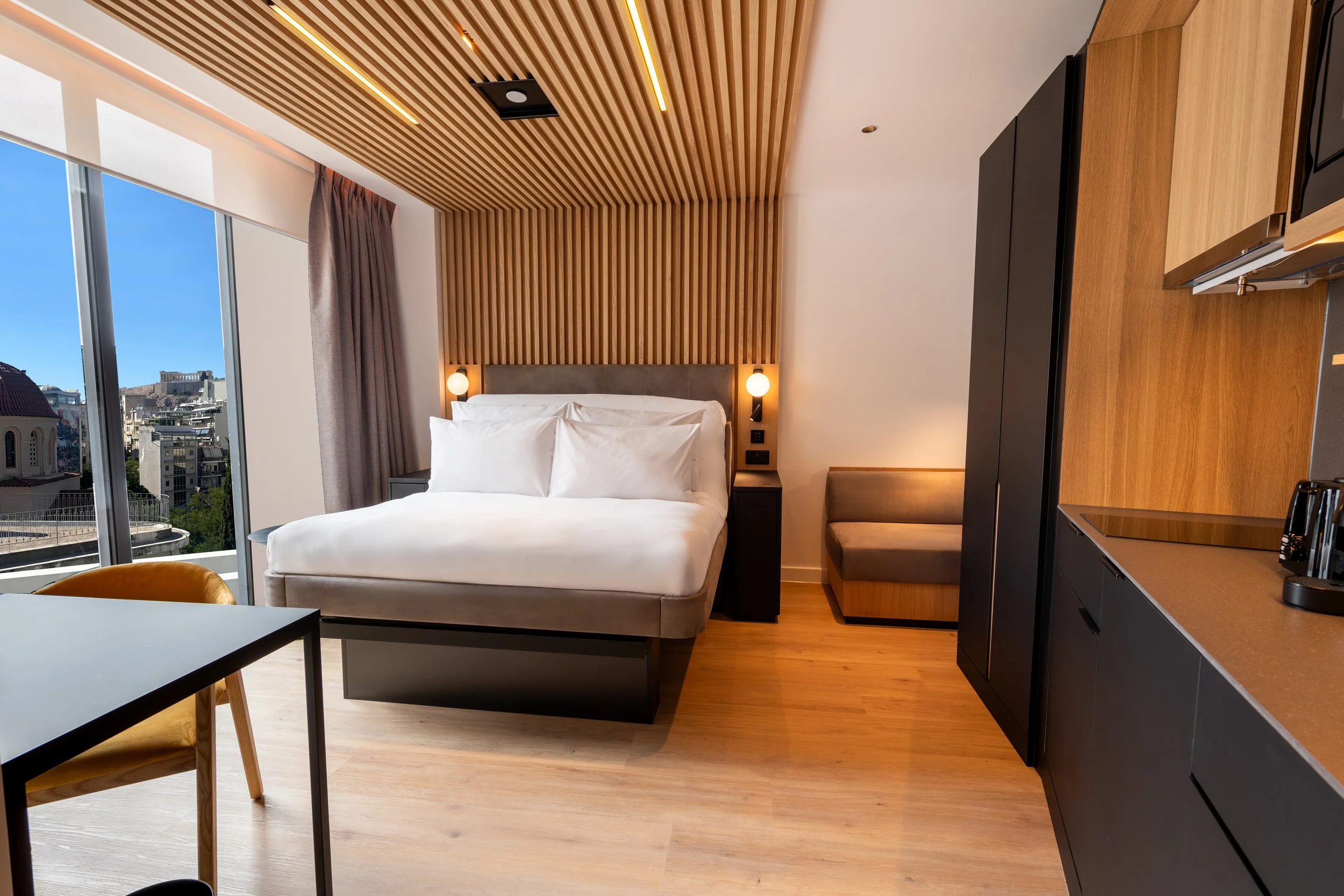 Bedroom with Queen size bed, desk and kitchen