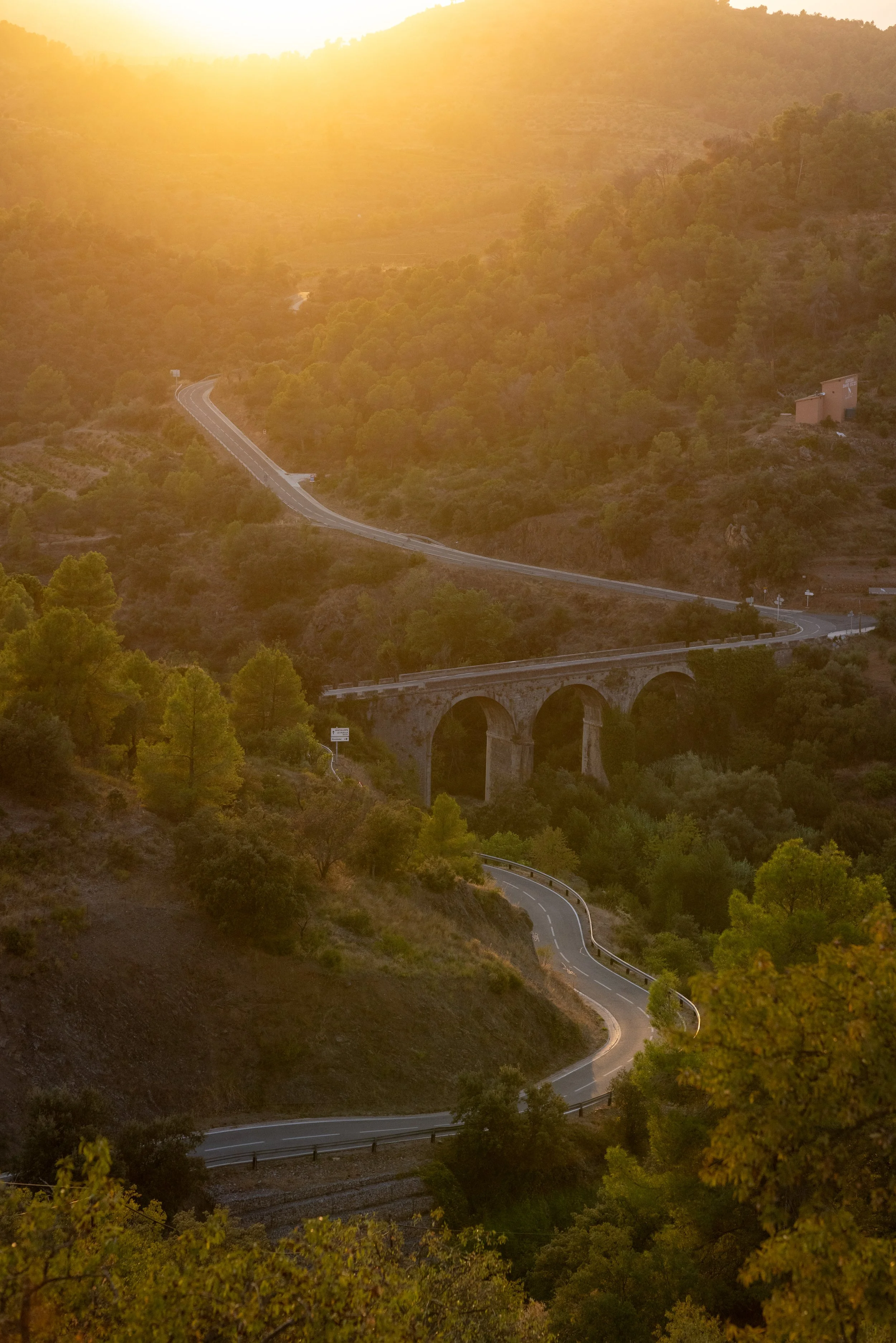 Scenic Priorat landscape photography: a winding mountain road near ORA Priorat at sunset.