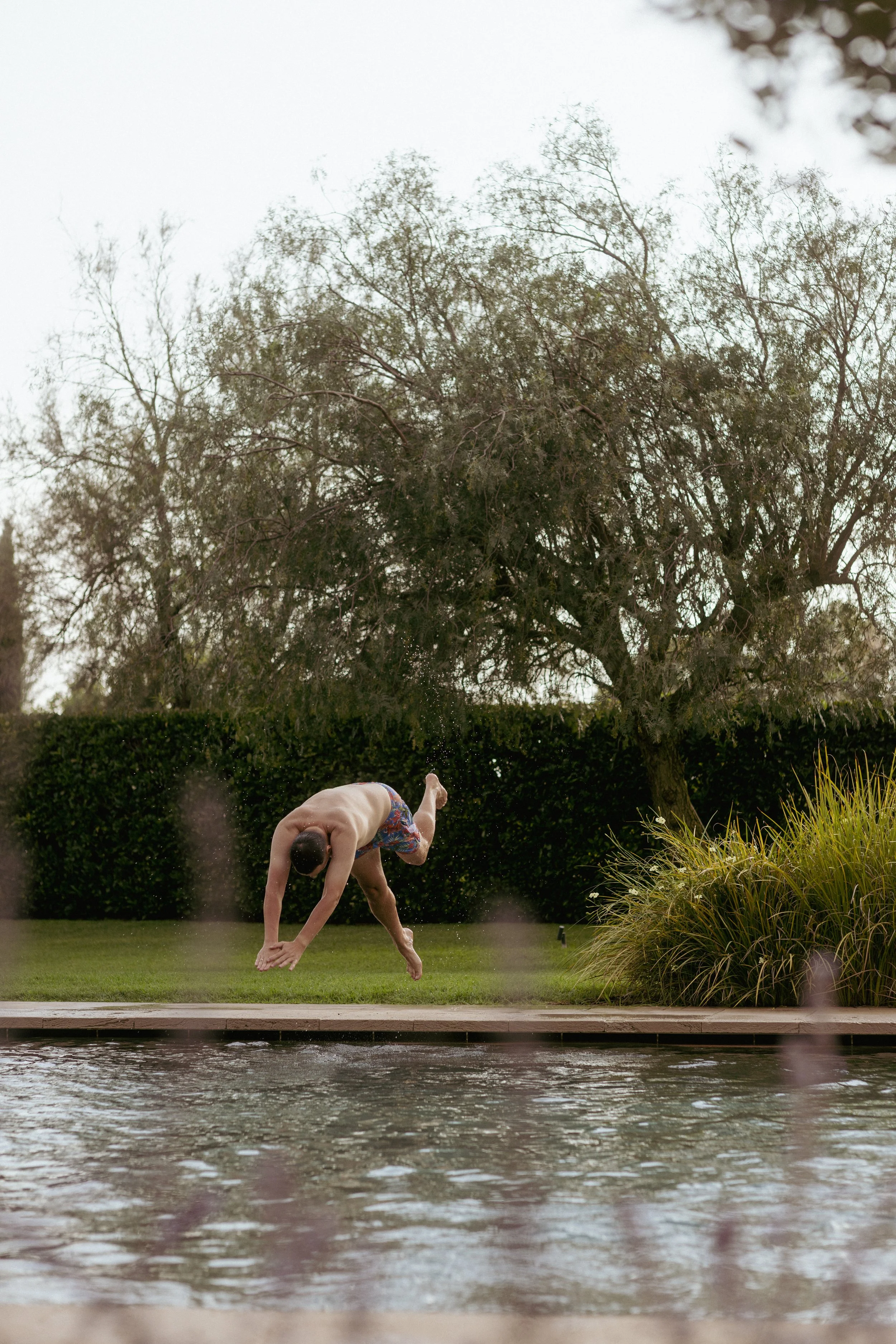 Hotel Peralada lifestyle photography with a person jumping into the swimming pool, Catalonia, Spain.