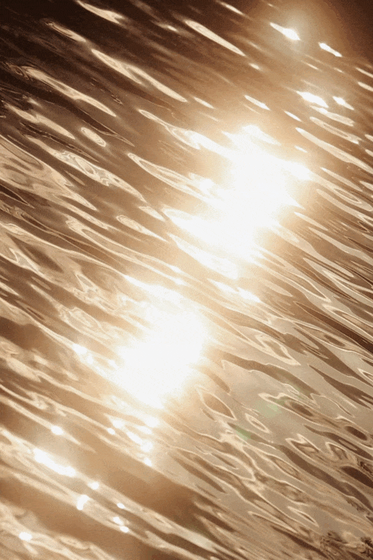 Cinematic sunlight reflections on rippling pool water at Hotel Perelada.