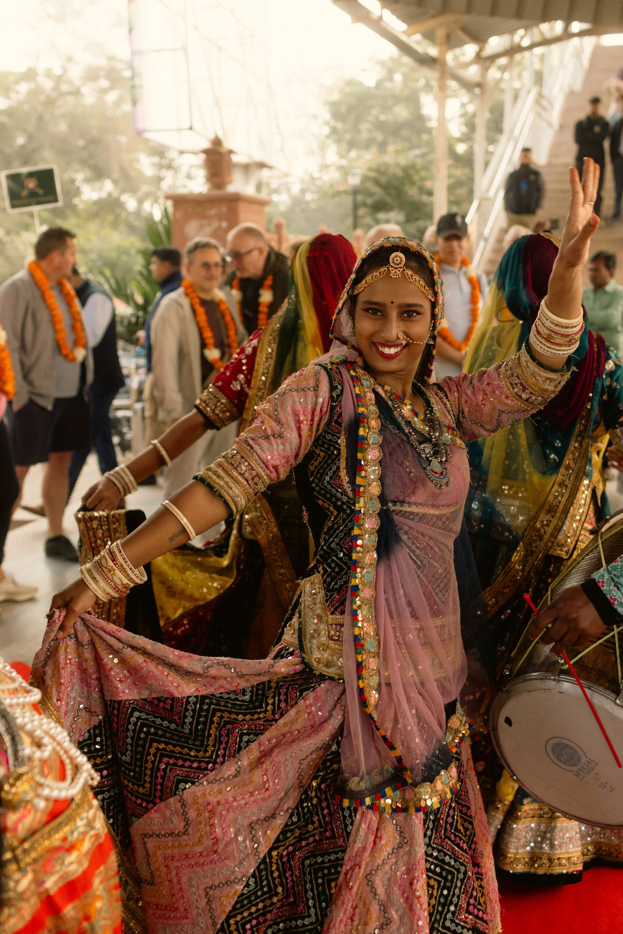 Luxury train travel photography: A candid lifestyle shot of traditional Indian dancing during a cultural performance for Deccan Odyssey guests. Professional hospitality and event portfolio imagery.