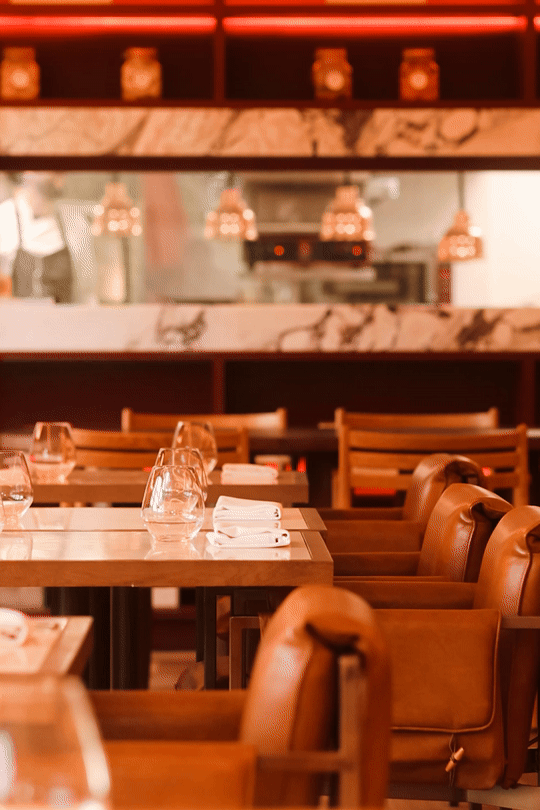 The art of hospitality at Mas d'en Bruno: a warm, modern dining space in Priorat featuring the dynamic movement of chefs in the open kitchen.