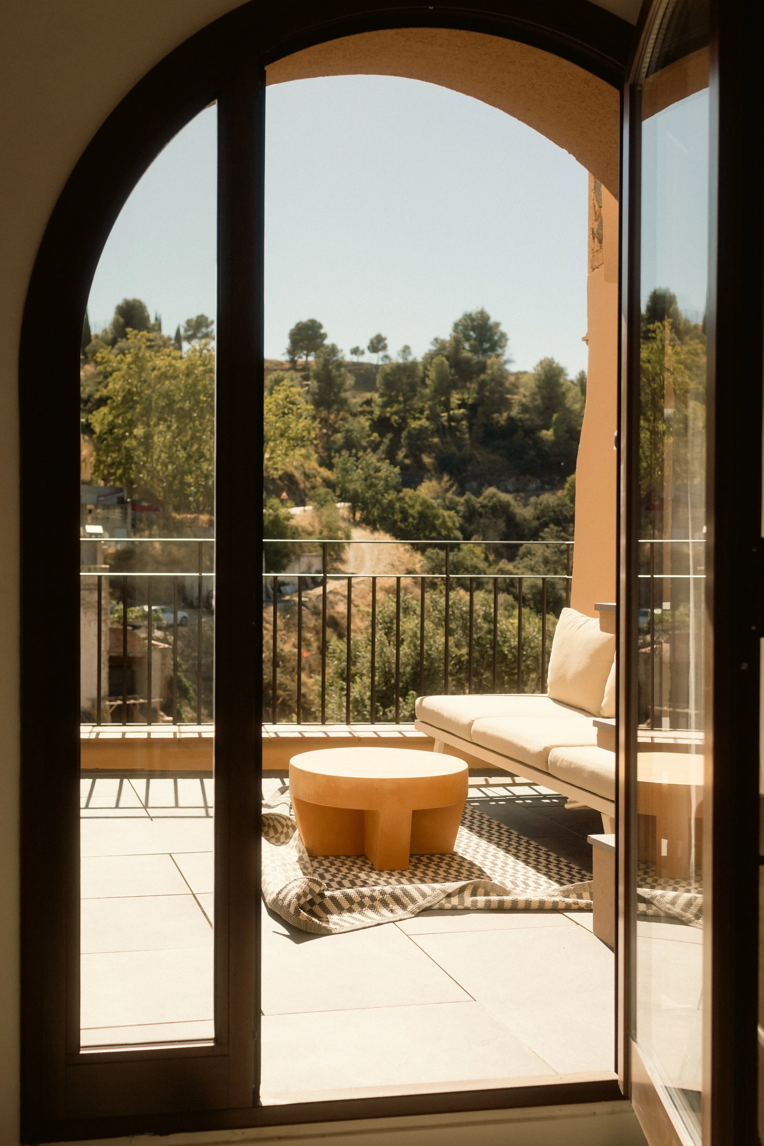 ORA Priorat hotel photography, outdoor balcony with seating and views of the surrounding hills, Catalonia, Spain.
