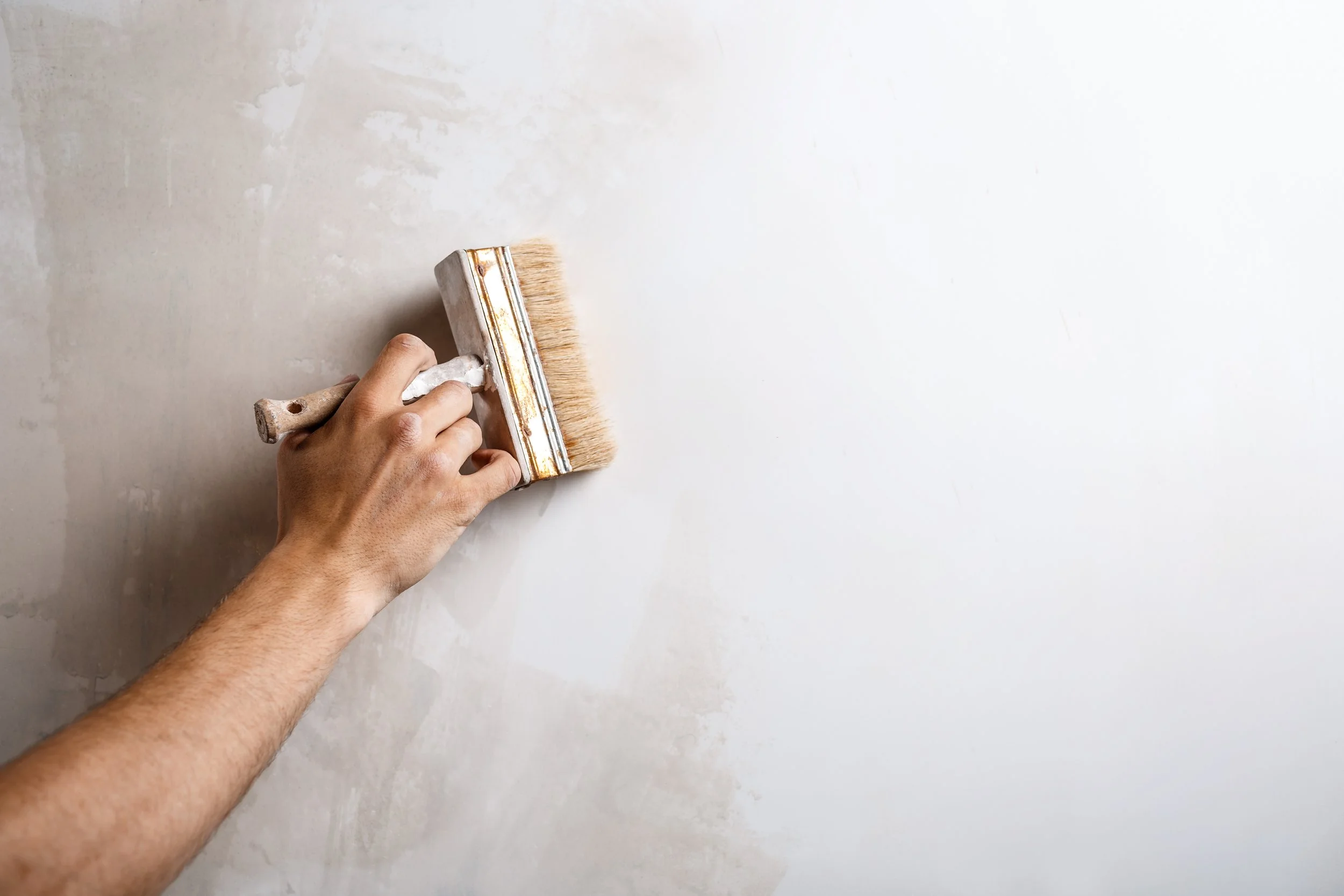 close-up-hand-painting-wall-with-brush.jpg