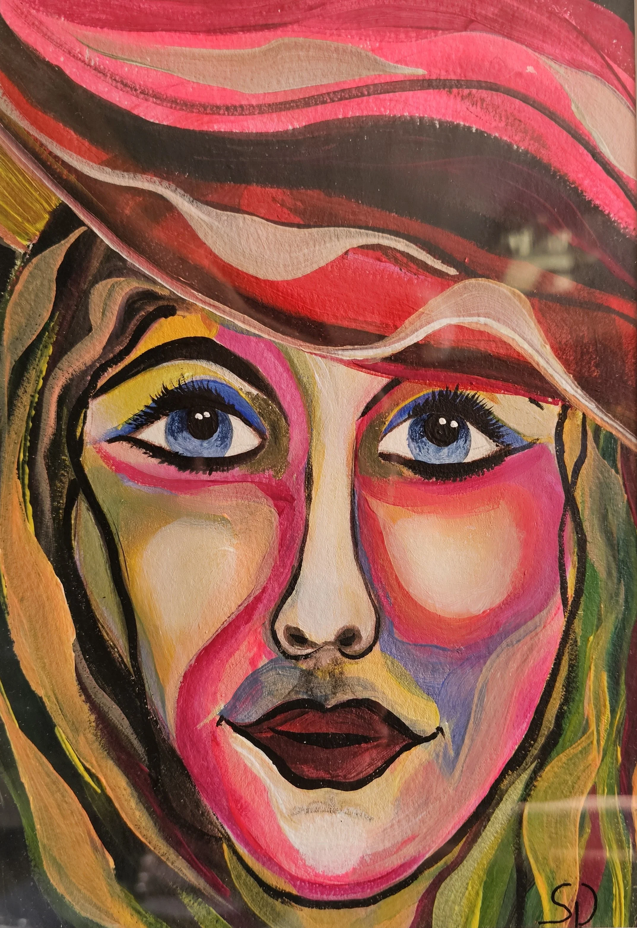 Colorful portrait of a woman's face with blue eyes, painted in an abstract style with vibrant pinks, blues, yellows, and greens, and a red and pink hat partially covering her head.