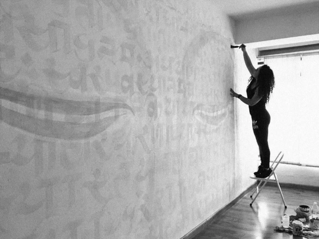 ink artist at work on wall
