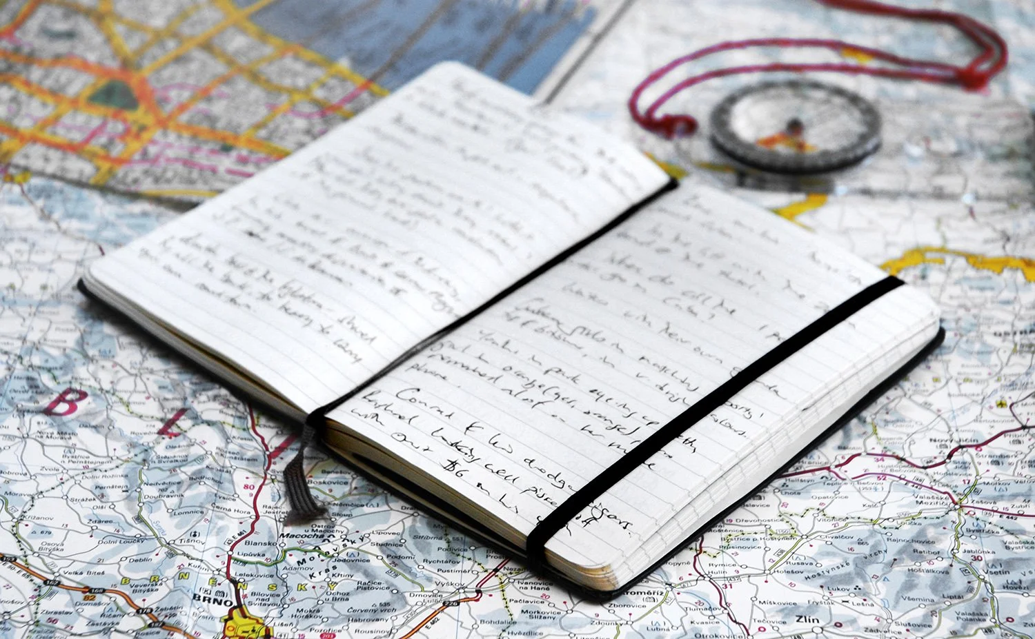 moleskine notebook with notes on a map