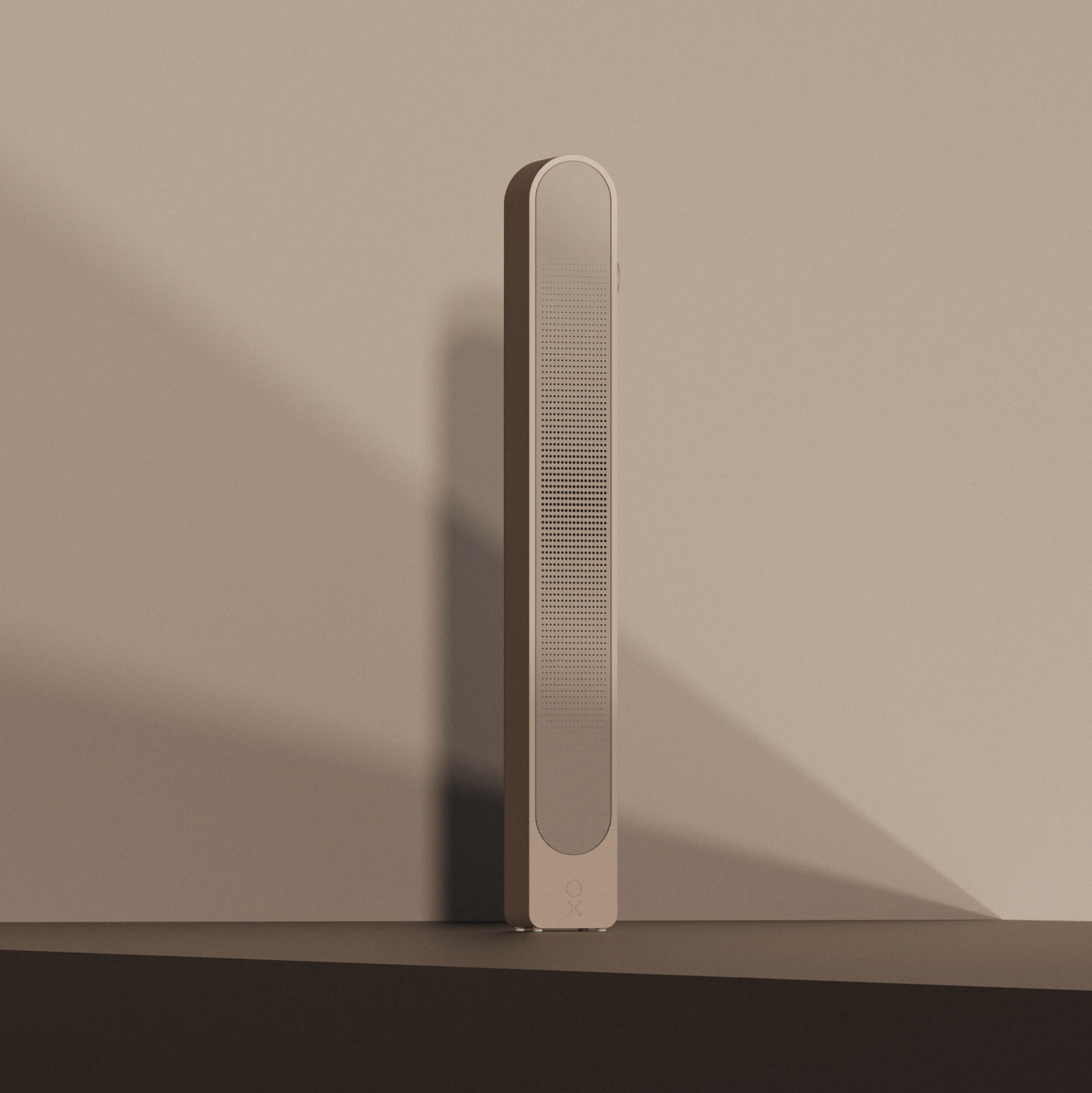 A tall, slim, modern beige speaker or device with a textured front panel, positioned on a surface against a plain beige wall.