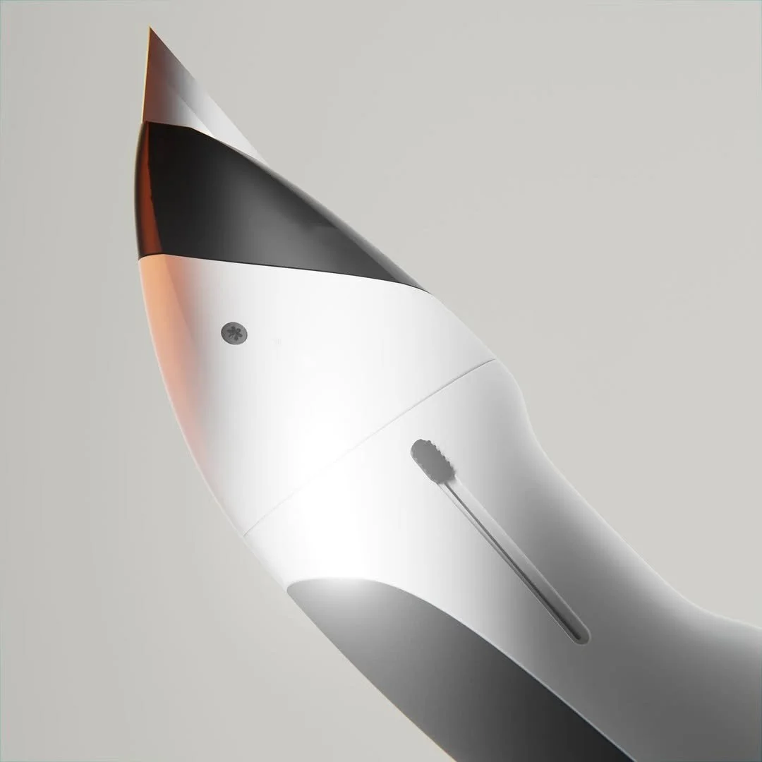 Close-up of a sleek, modern, white and black hair dryer with a metallic finish, placed on a light gray background.
