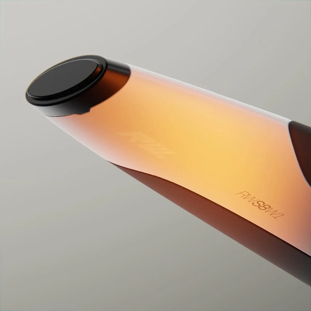 Close-up of a device with a sleek black and orange design, displaying the words 'FAIRNESS' and 'EMPATHY' on its surface.