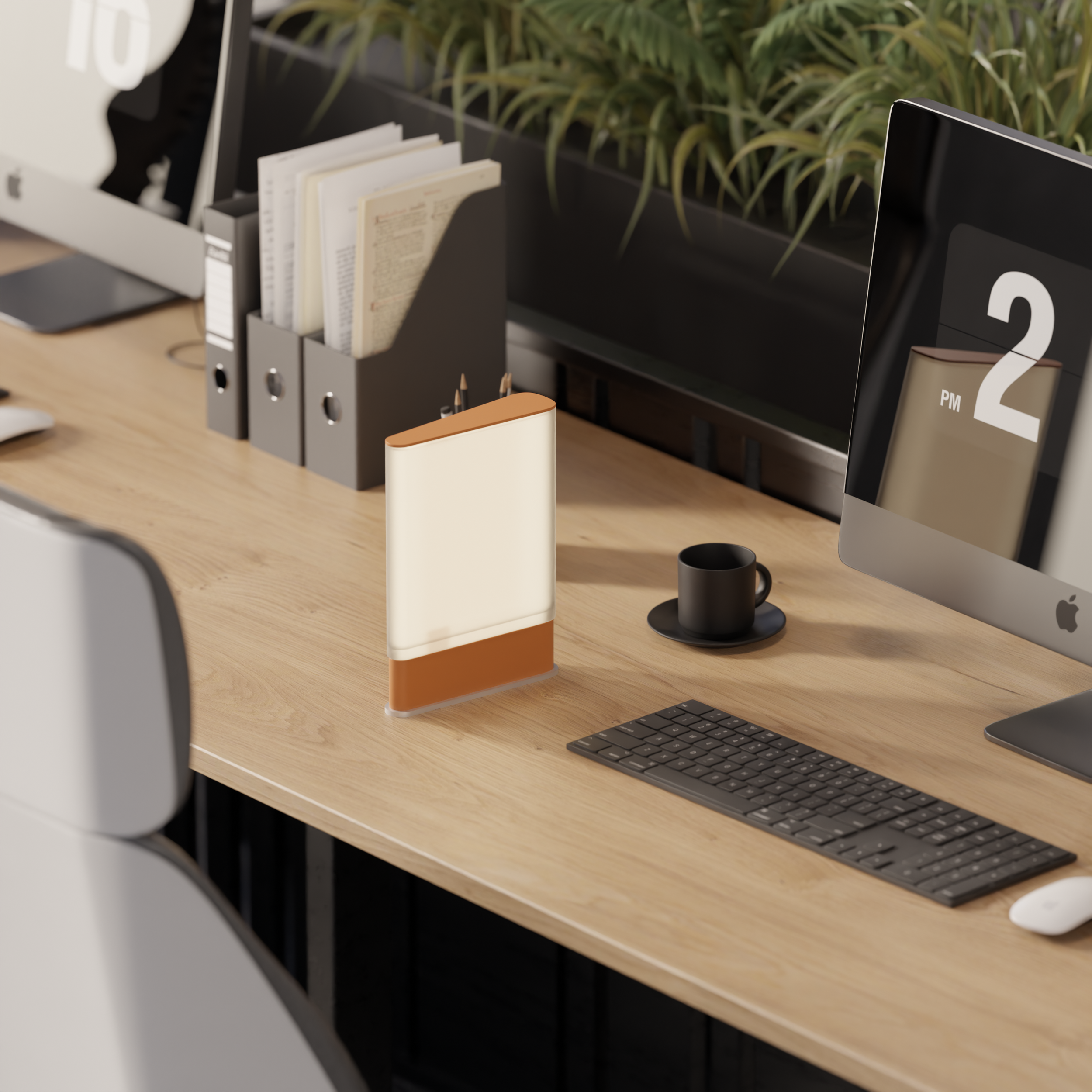 Office desk with computer monitor displaying 2 PM, a black cup and saucer, a keyboard, and a white and brown desk organizer on a wooden surface, with gray file organizers and a green plant in the background.