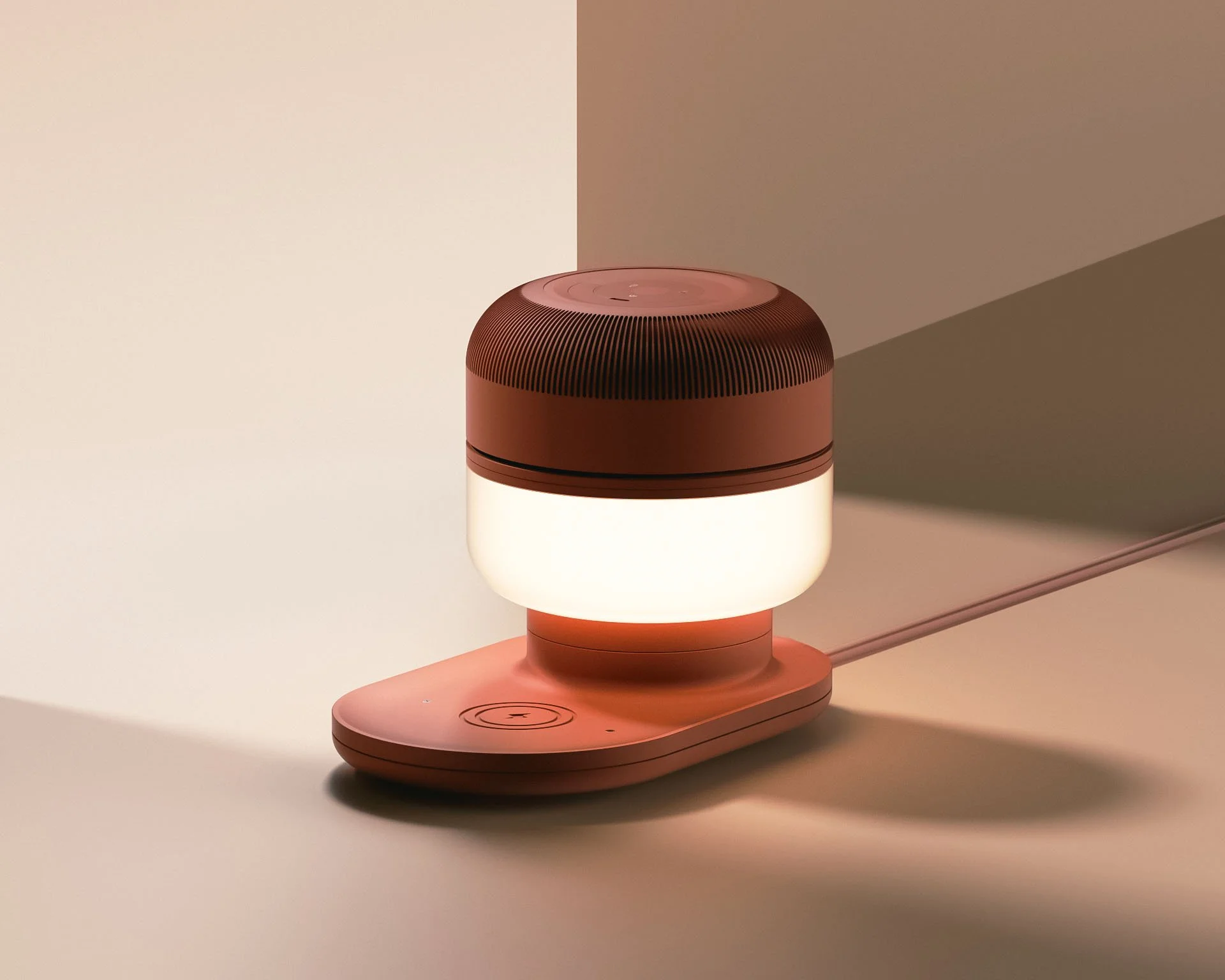 A modern, round, pink smart device with a glowing white light sits on a pink base with a power button icon, connected by a cord in a minimalistic environment.