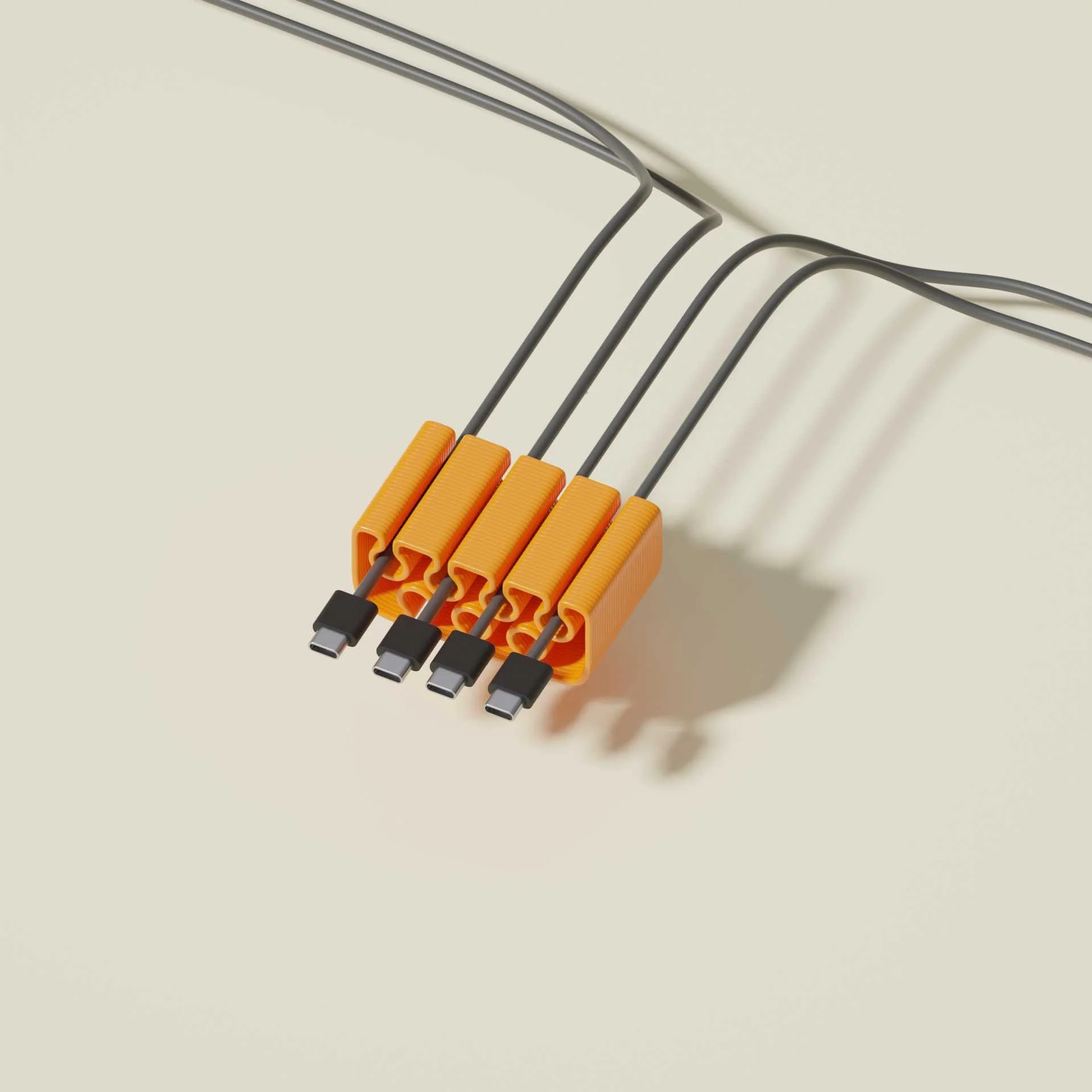 Close-up of five orange adapters connecting to black charging cables for electronic devices on a light-colored surface, casting shadows.
