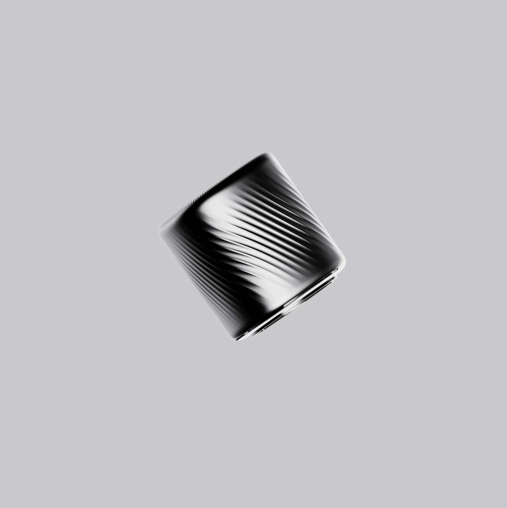 A black and silver metallic object with a textured pattern, floating against a light gray background.