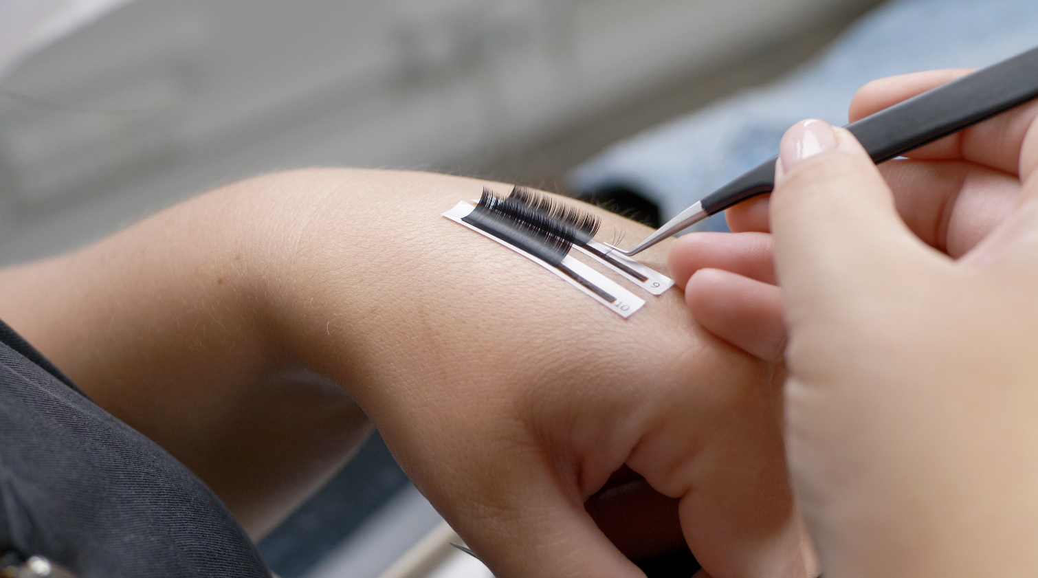 Technician fanning ultra fine lashes before application