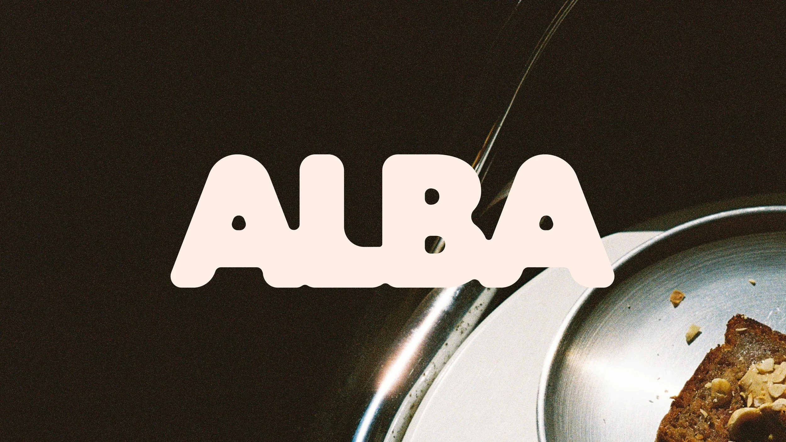 Close-up of a plate with food, with the word 'ALAB' written in white text overlay.