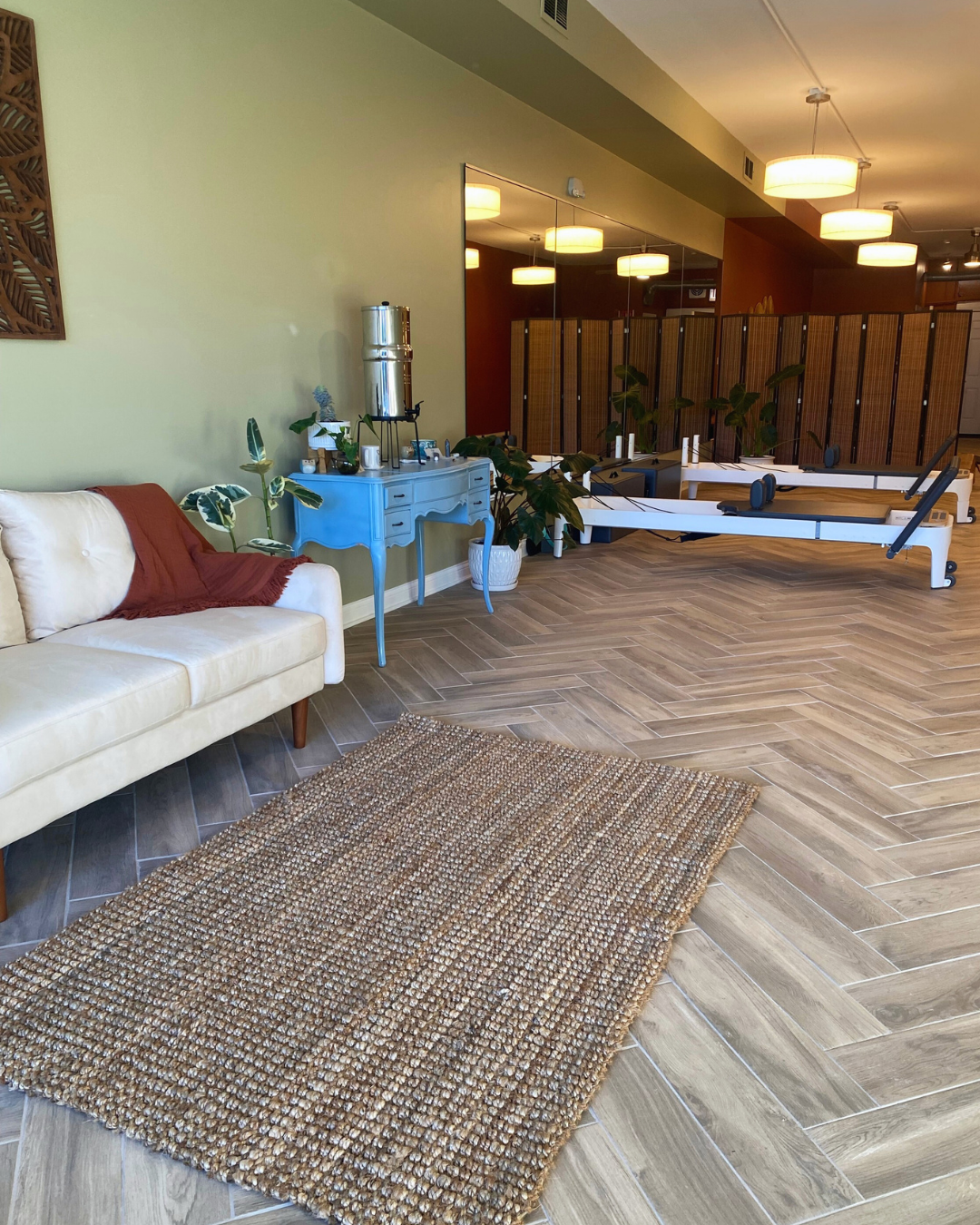 View of studio, including welcoming area and Pilates space with reformers