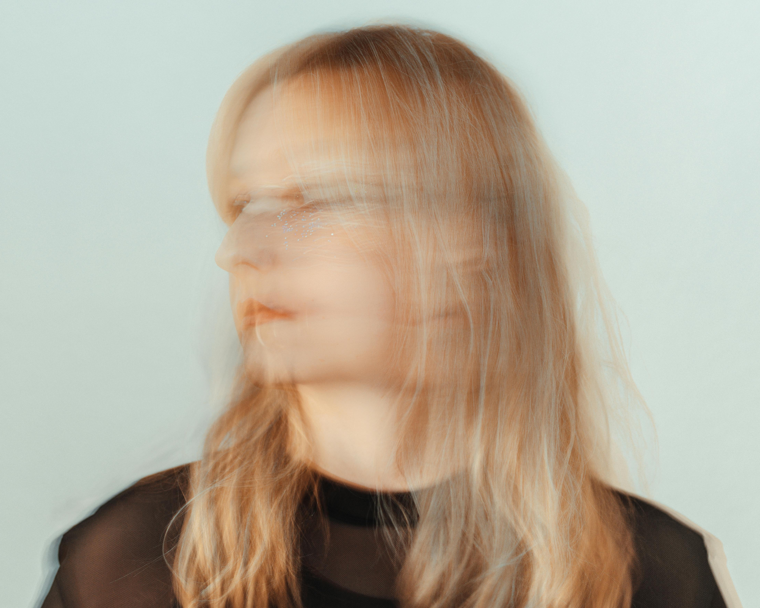 Blurred motion portrait of a woman representing the mental exhaustion, chronic stress, and identity loss experienced by special needs caregivers facing burnout