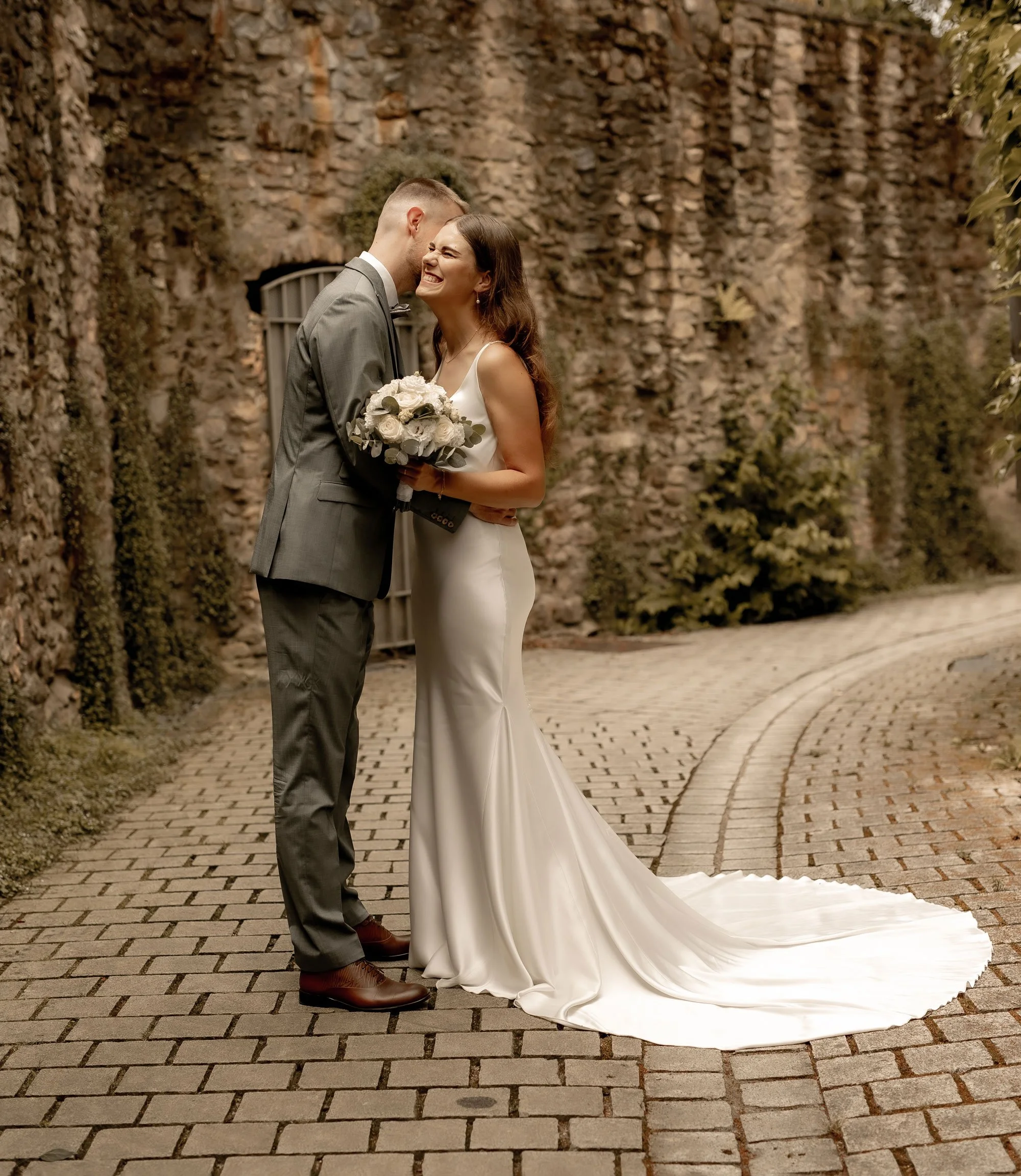 Brautpaar steht freudig auf einem Weg