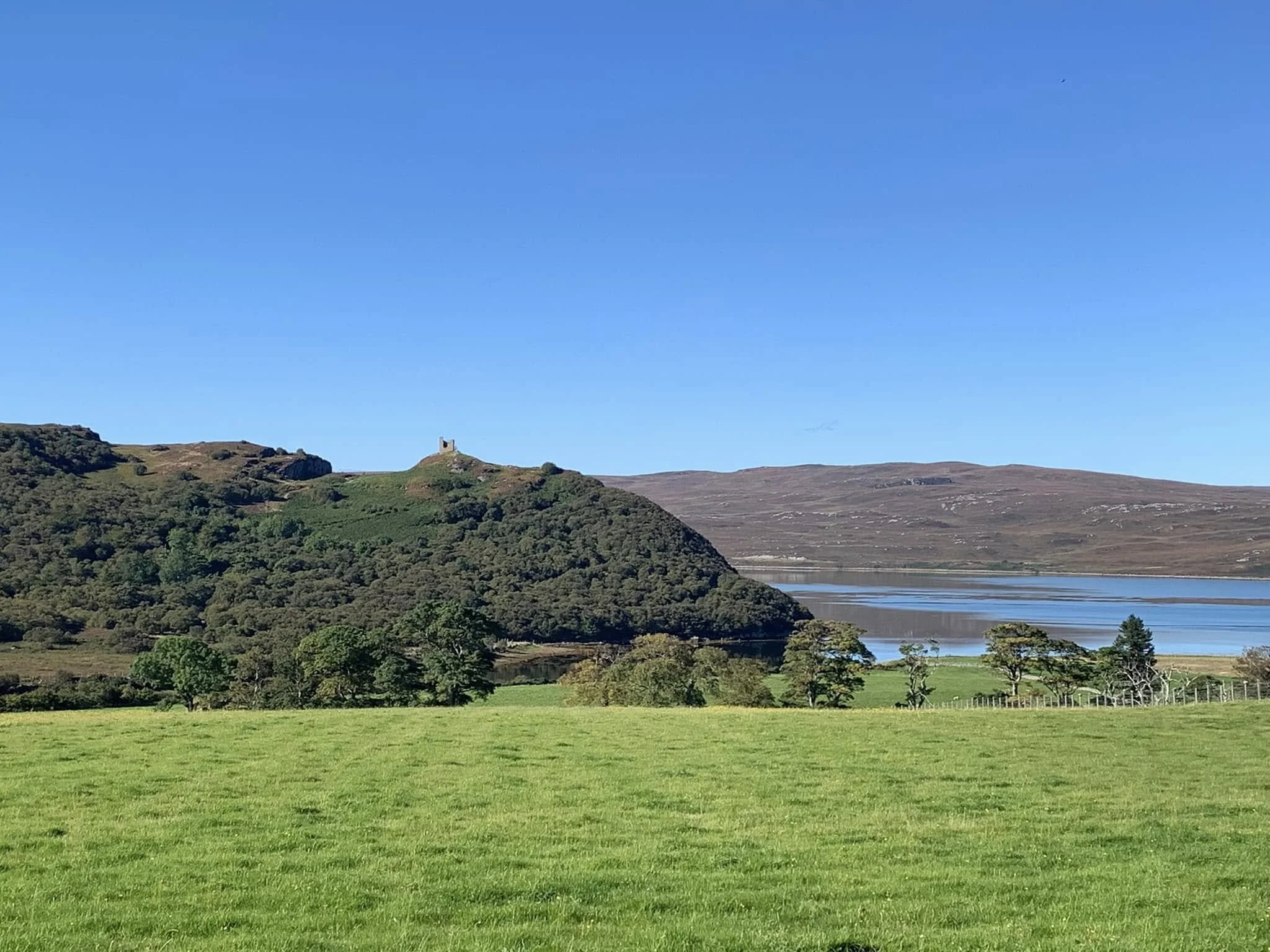 A scenic view of Castle Varrich under a clear blue sky.