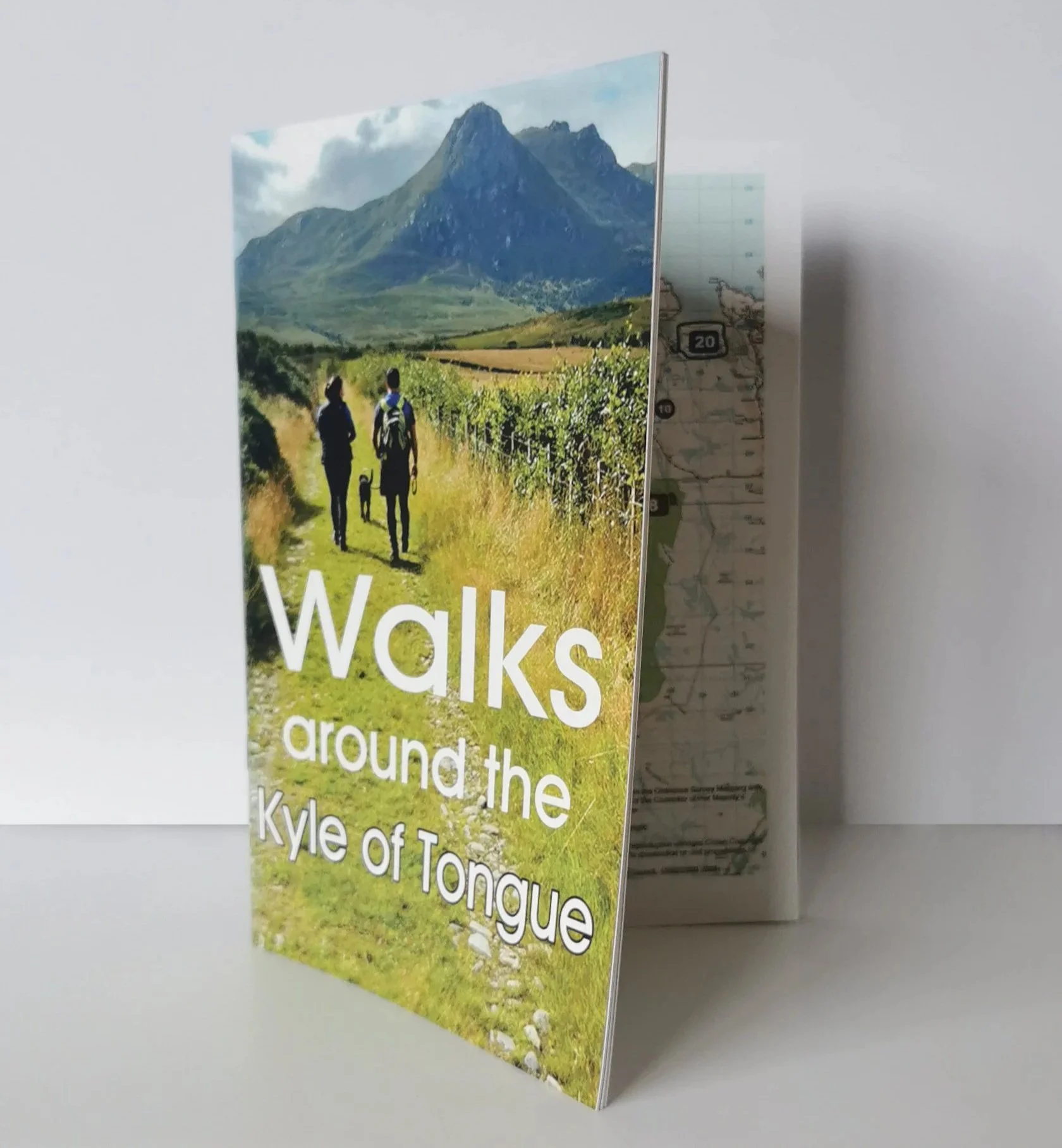 A booklet created by UpNorth titled 'Walking around the Kyle of Tongue' with a scenic view of Ben Loyal with two hikers and a dog in the foreground.