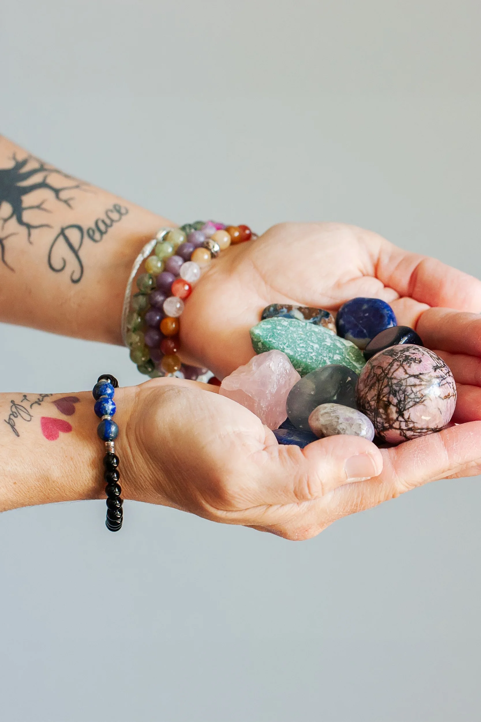 Deanna Scaldaferri's hands holding crystals during an energy work session, representing Reiki healing and chakra balancing in Charlotte, NC.