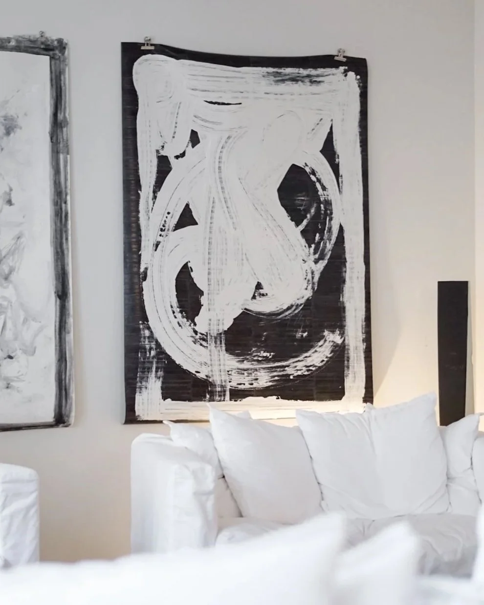 Abstract painting of two intertwined white bodies against a deep black background, expressive contemporary figurative artwork by Copenhagen artist Mathias Philip.