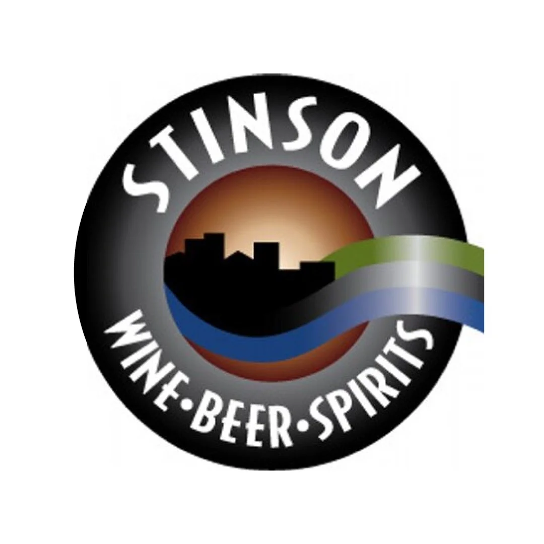 Circular logo with a city skyline, sunset, and flowing river, with the text 'Stinson' at the top and 'Wine Beer Spirits' at the bottom.