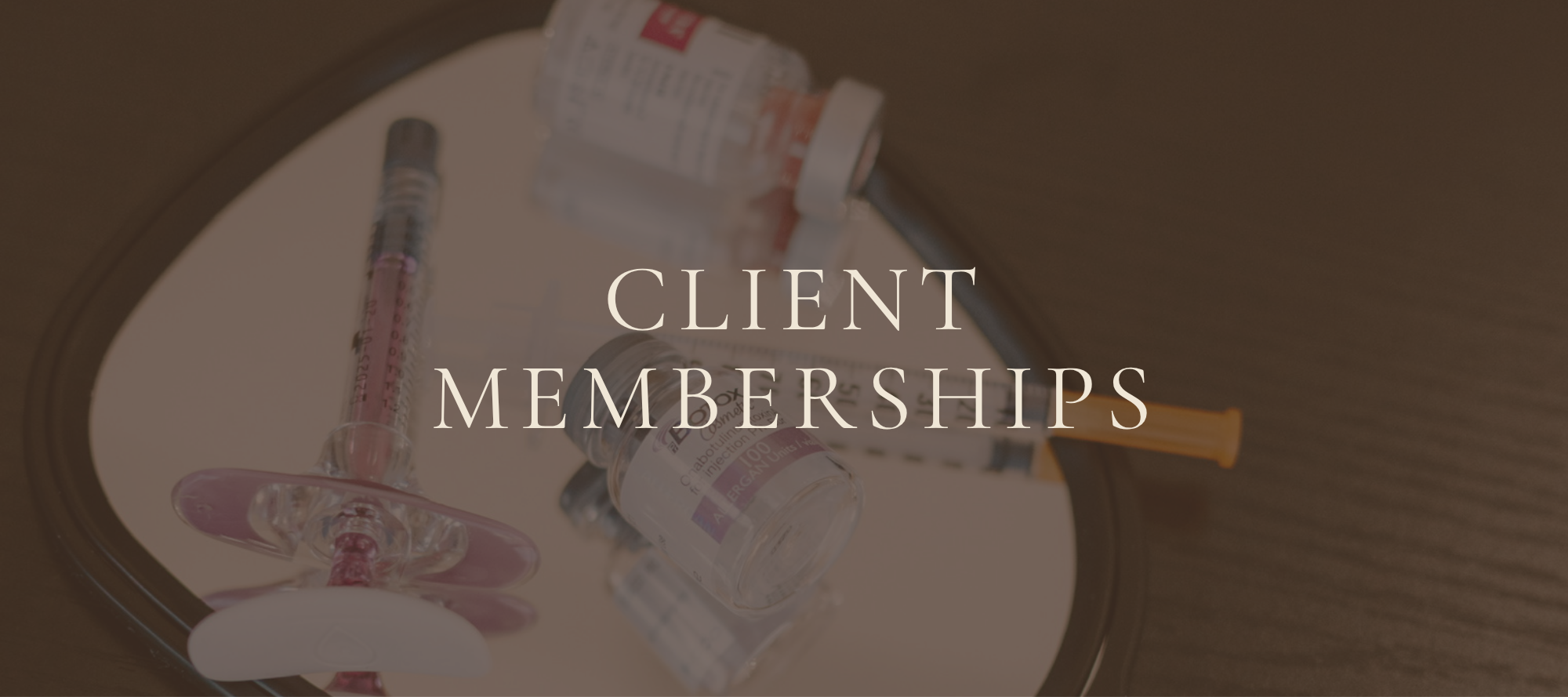Medical syringes and vials with the overlay text 'Client Memberships'