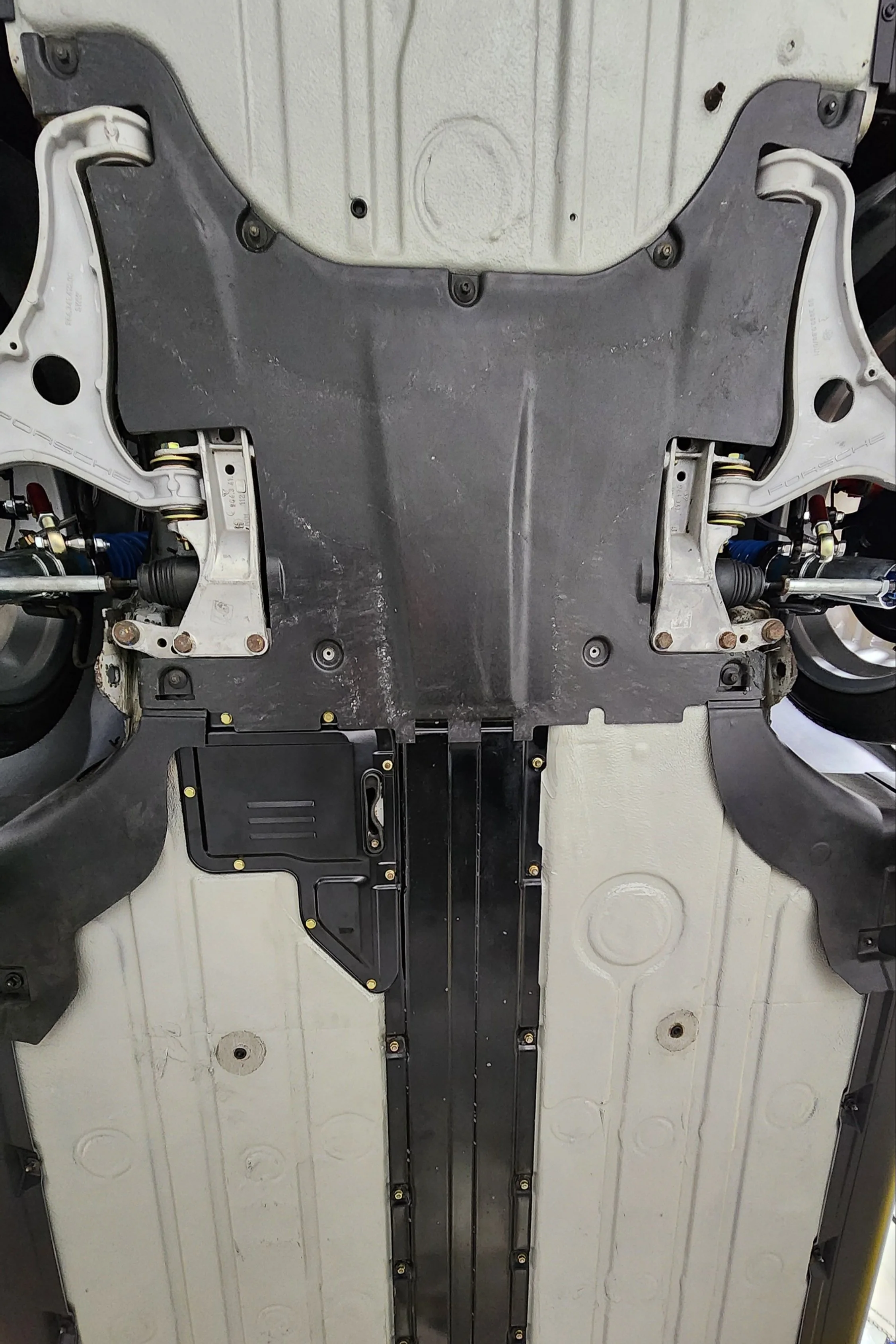 Underbody of a Porsche 964 showing suspension components and chassis