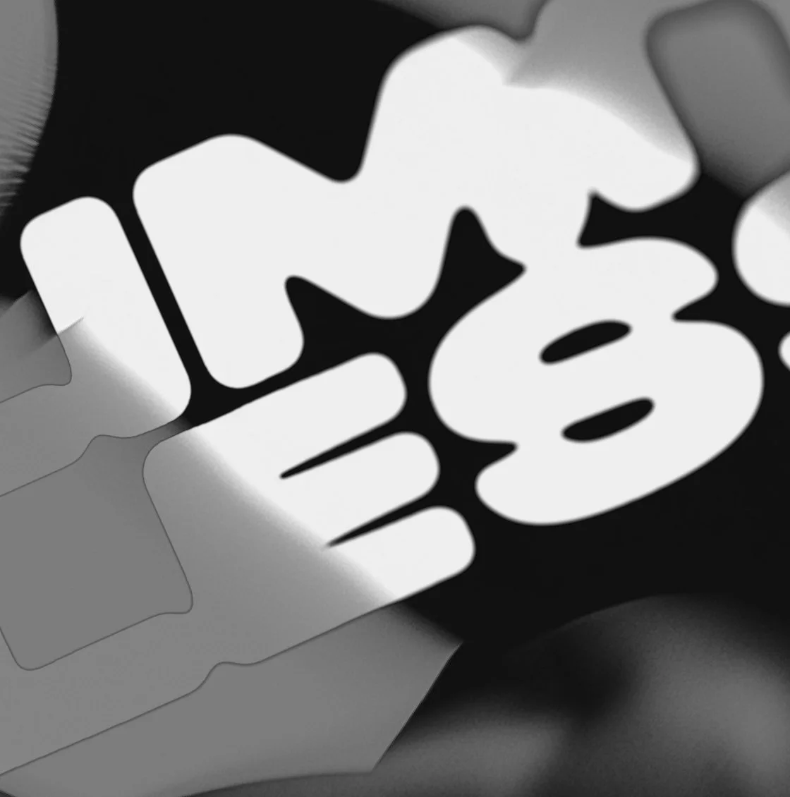 A high-contrast close-up of distorted black and white typography, creating a bold visual effect that merges branding, design innovation, and experimental aesthetics.