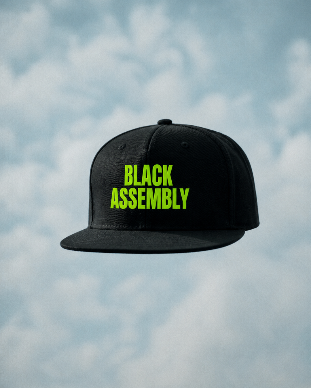 A black baseball cap floating against a cloudy sky, with the words "BLACK ASSEMBLY" in bright green text on the front.