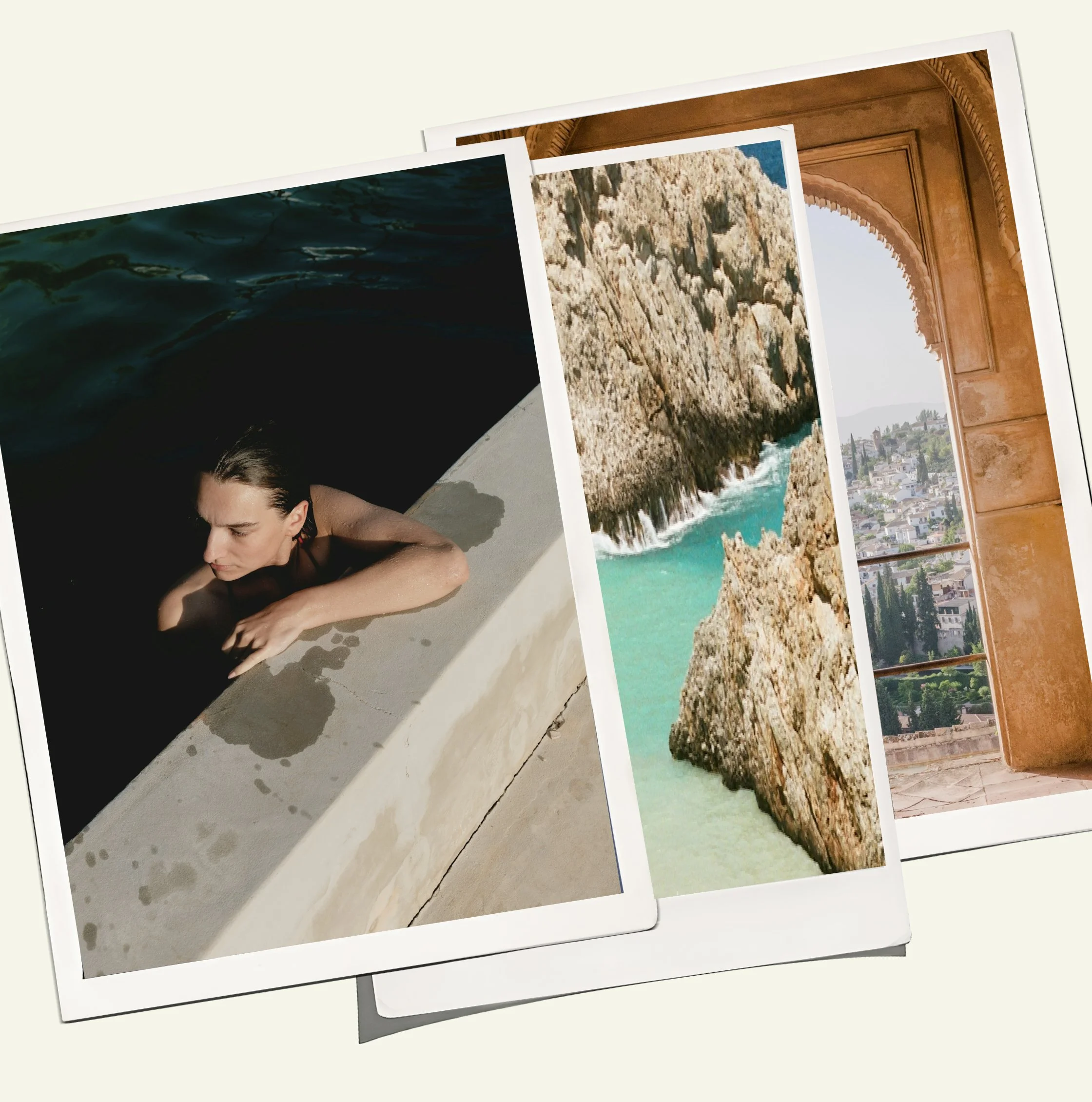 Close-up of printed photographs stacked together, featuring a woman lying on the ground, a rocky coastline with ocean waves, and a scenic cityscape.