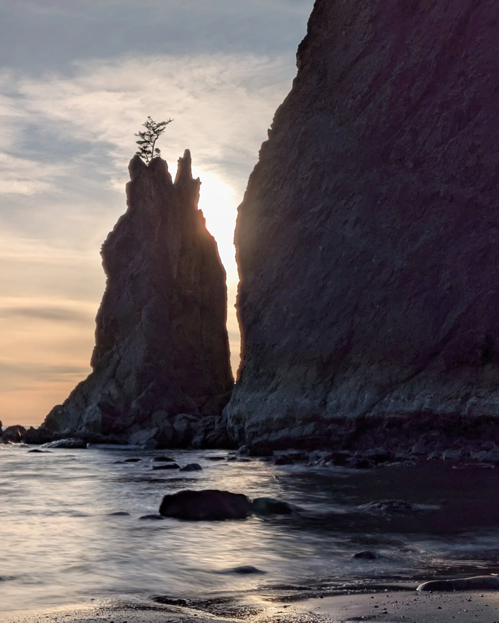 sunset over rocky beach with coastal boulders landscape photography