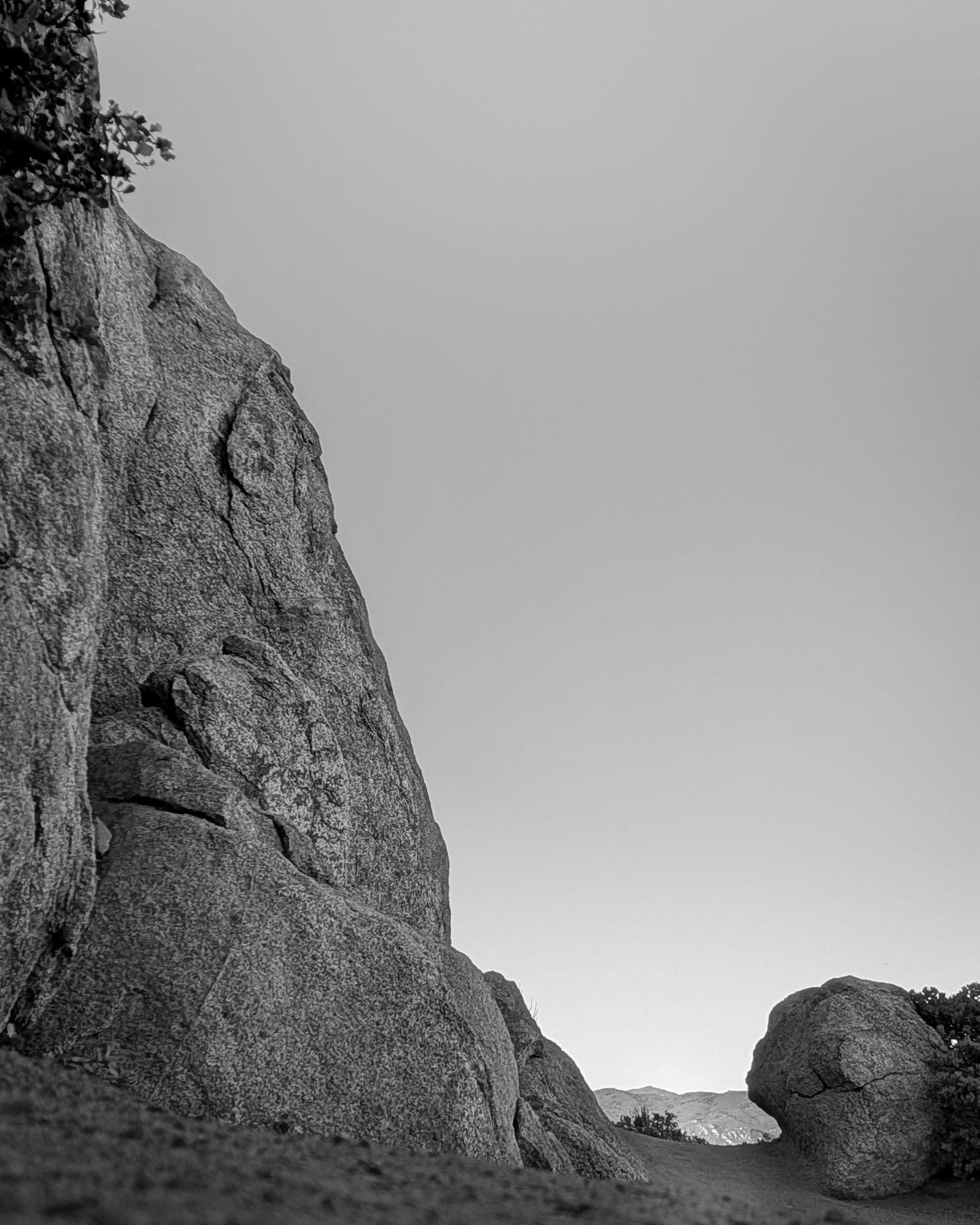 Black and white image of anthropomorphic granite stone at the switchback of Cush-Pii (formerly known as Stonewall) trail in Cuyamaca State Park, Julian, CA | © Edge of Clarity Photo | Elizabeth Chaney 2026