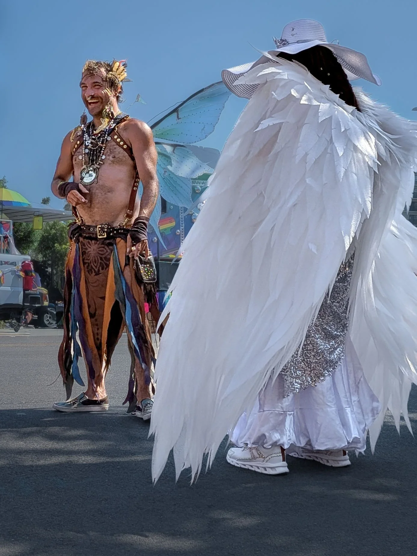 A participant wearing large white wings pauses during the San Diego Pride Parade.
San Diego, CA | © Edge of Clarity Photo | Elizabeth Chaney 2026
