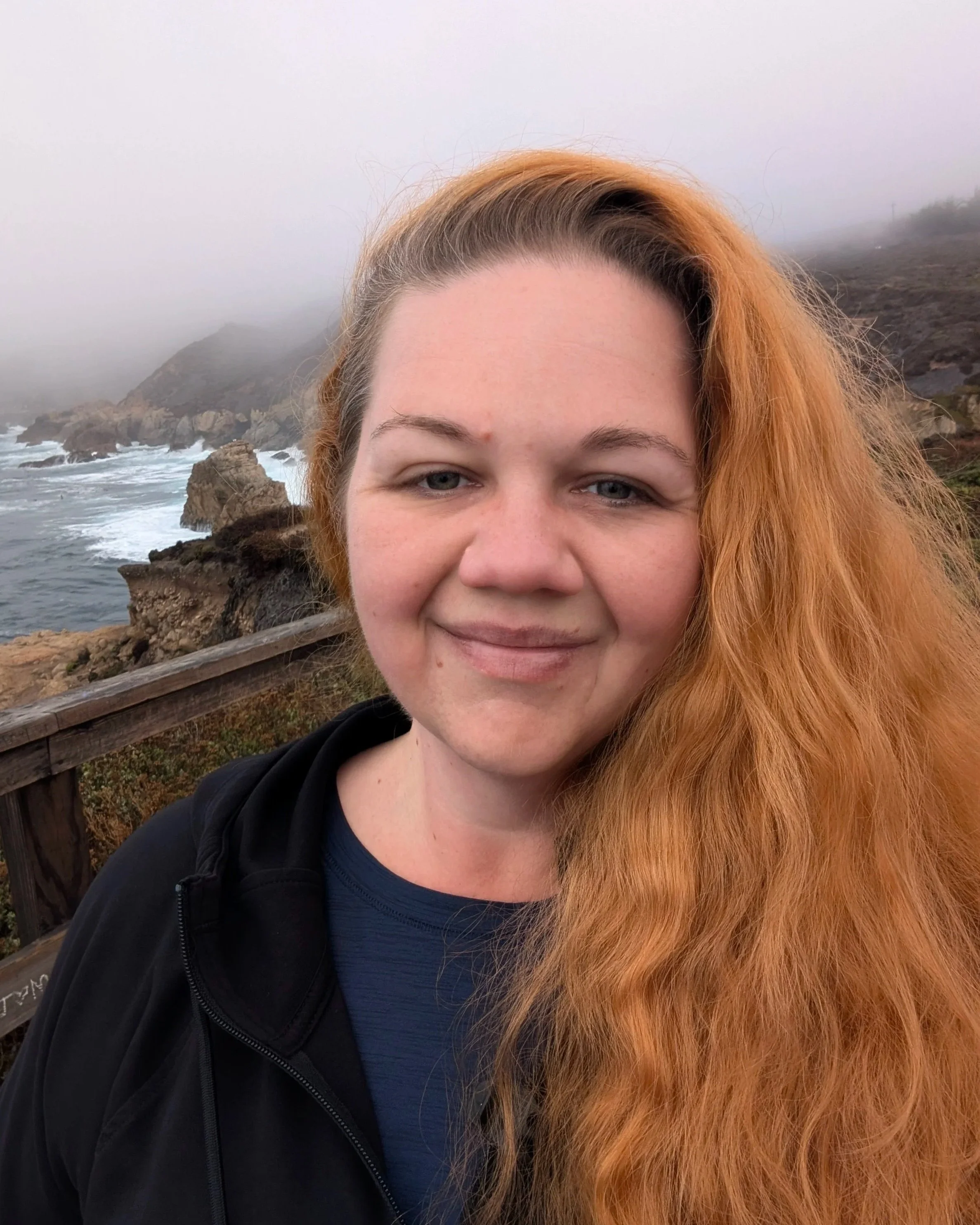 landscape photographer portrait at foggy coastal overlook