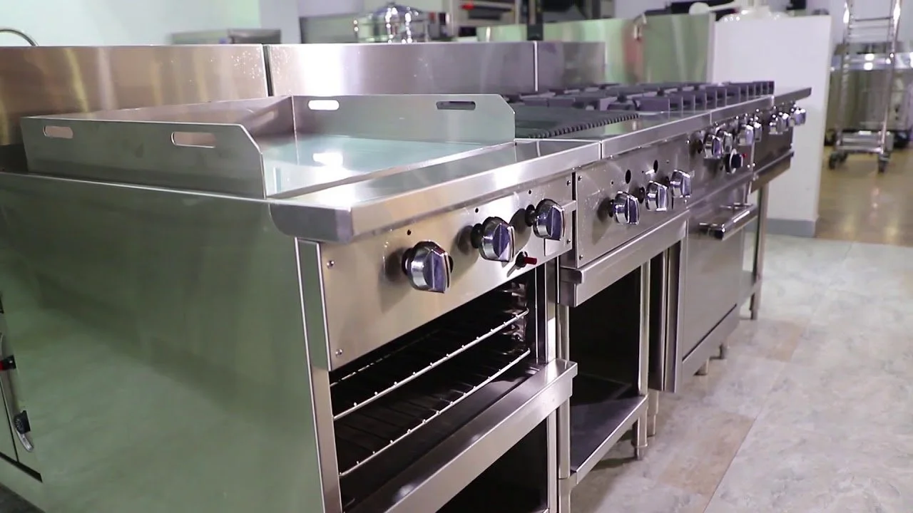 Commercial stainless steel stove with multiple burners and oven in a professional kitchen.