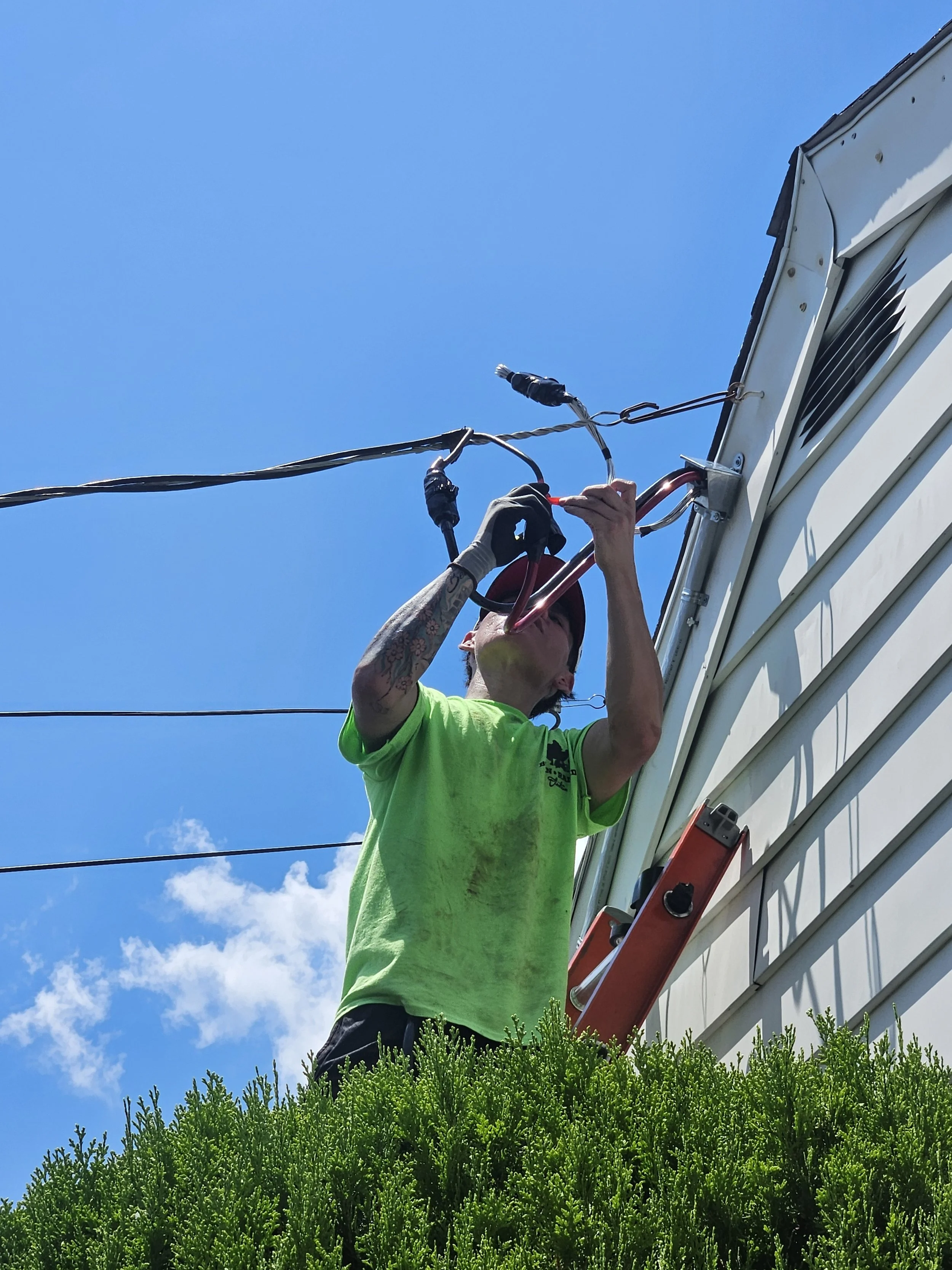 Electrician troubleshooting electrical repairs outside a residential home